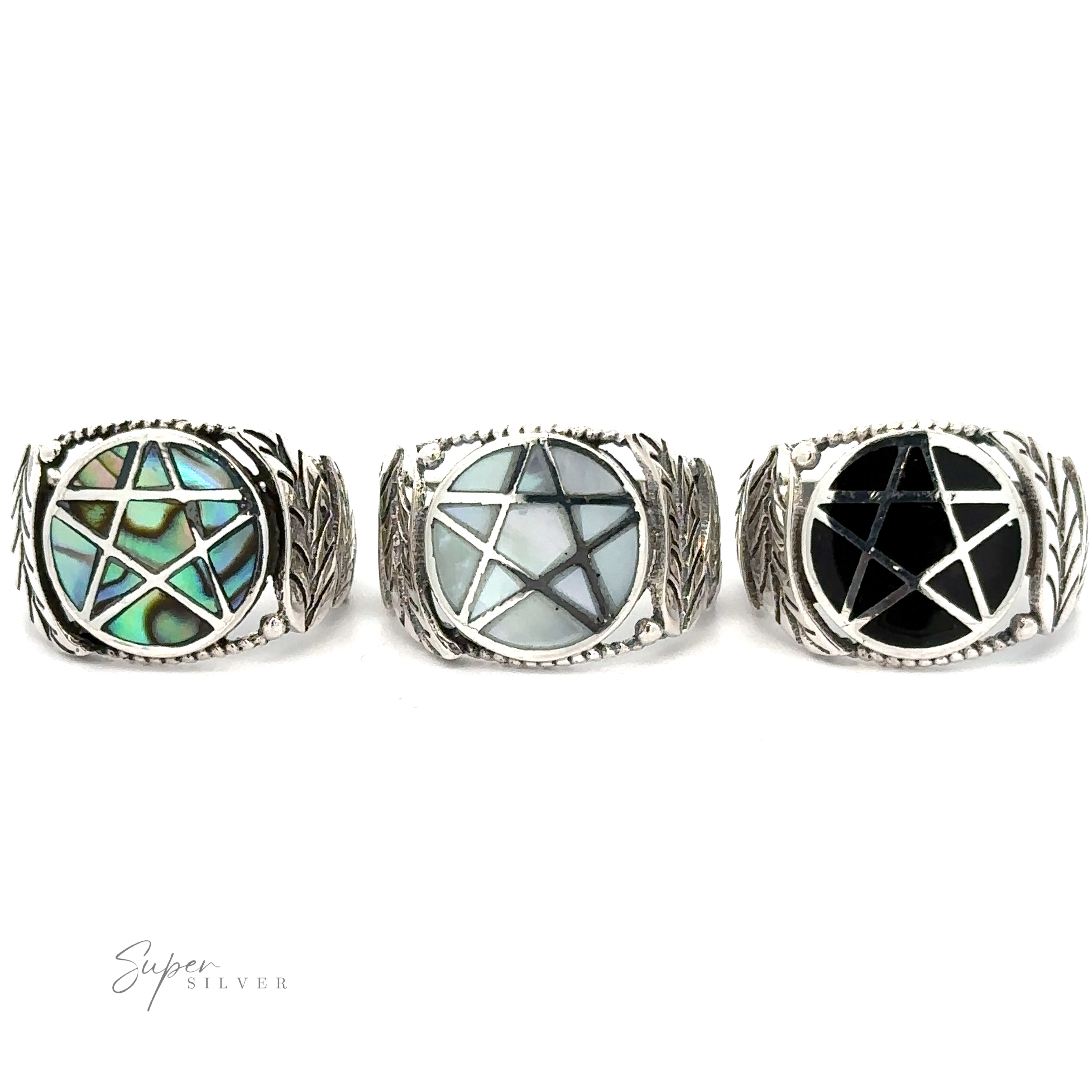 Three sterling silver rings with geometric gemstone inlays on a white background, including a Pentagram Ring with Inlaid Stones.