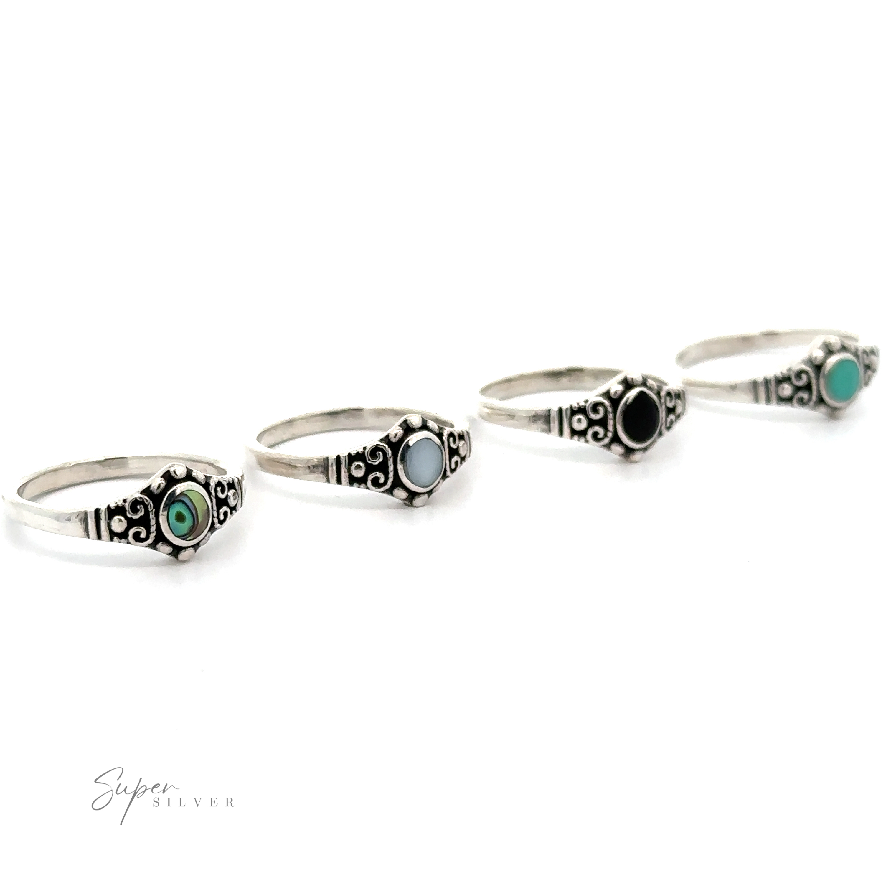 Four Dainty Inlaid Stone Rings With Silver Beads and Swirls on a white background.