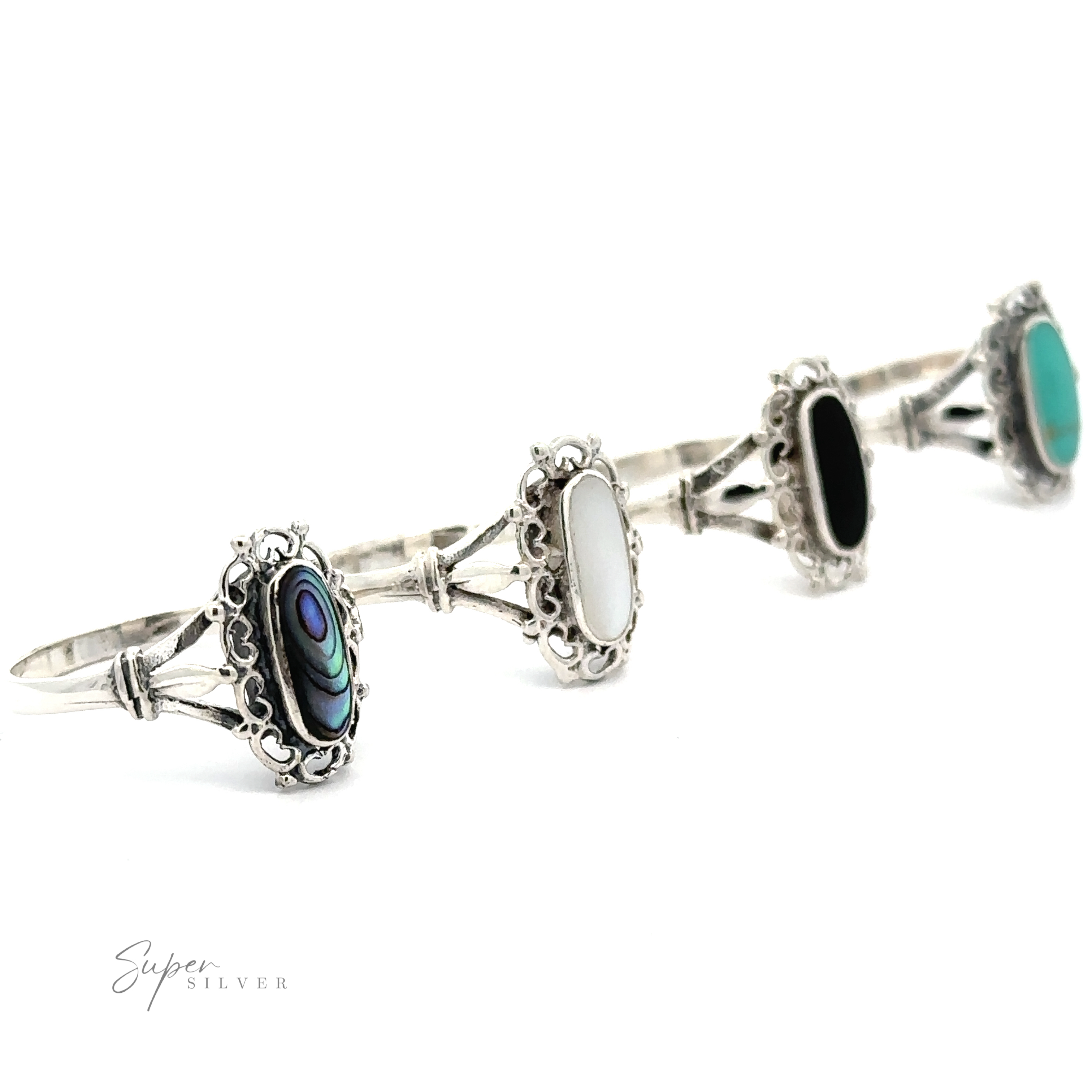 A row of Inlaid Oval Rings with Filigree Heart Border exudes a vintage appeal.