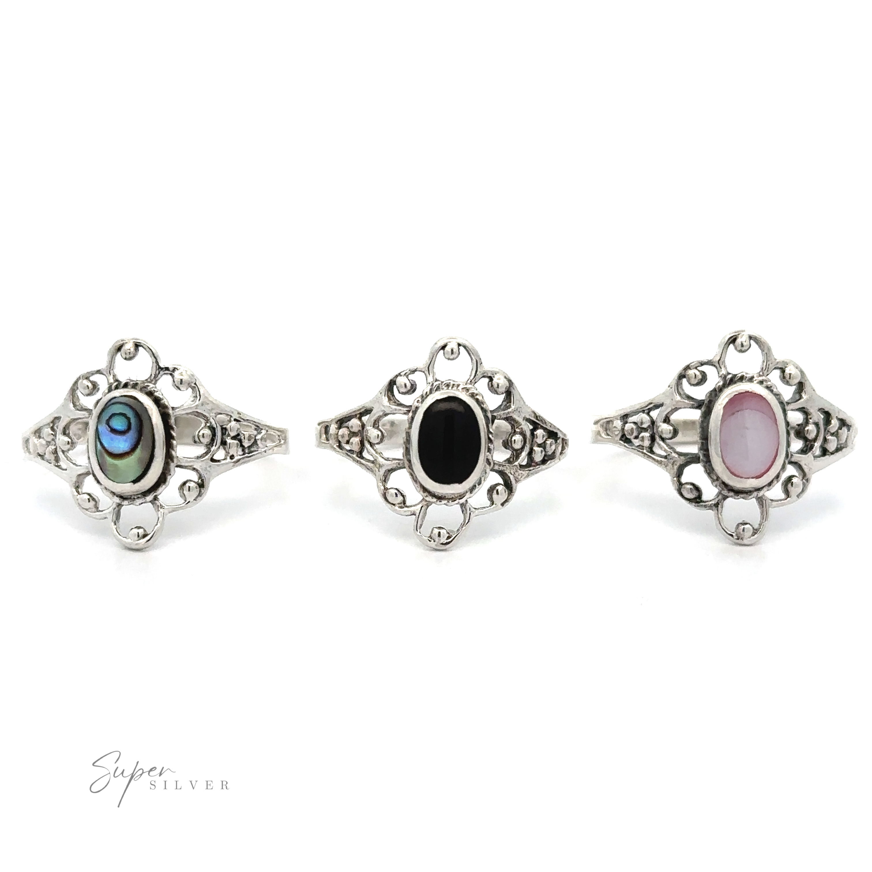 Three Vintage-Styled Flower Rings with Inlaid Stones, exuding vintage appeal, on a white background.