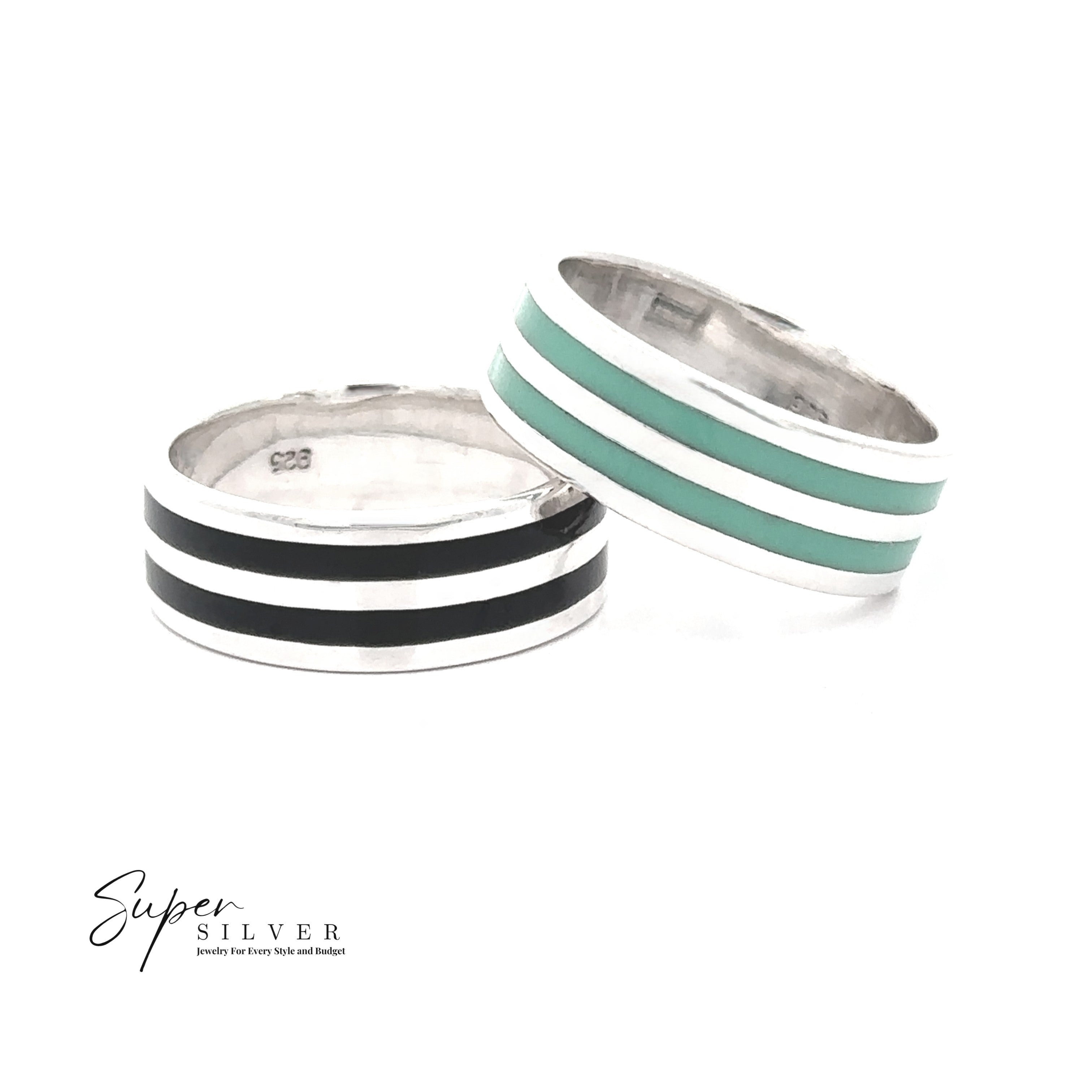 Two Double Stripe Inlay Band sterling silver rings—one with onyx-black enamel stripes and one with turquoise enamel stripes—are displayed on a white background. The "Super Silver" logo appears in the bottom left corner.