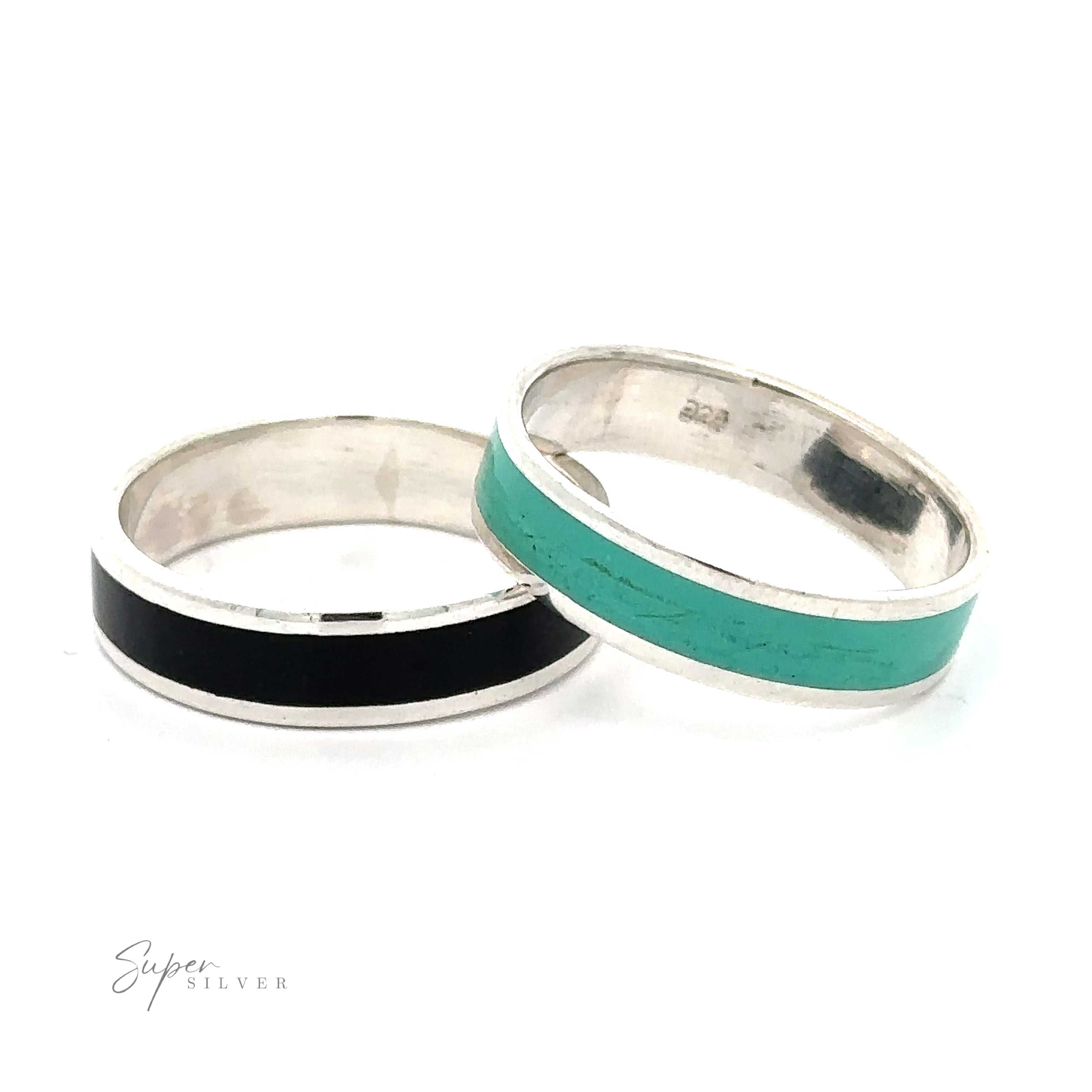 The Simple Inlay Band in sterling silver features minimalistic enamel inlays, one black and one turquoise. The two rings are arranged side by side on a white background.