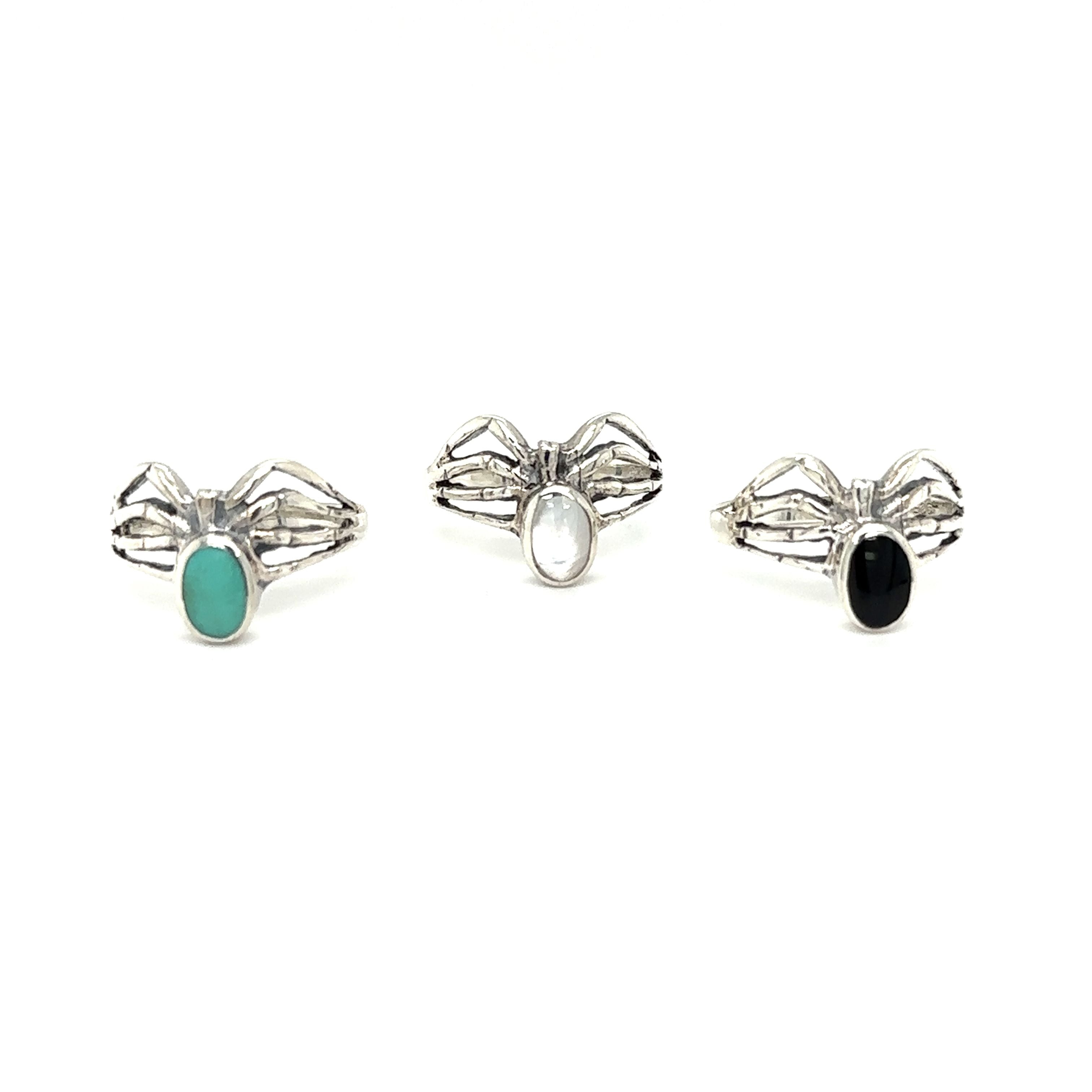 A set of three Super Silver Inlay Stone Spider Rings with mystical turquoise stones.