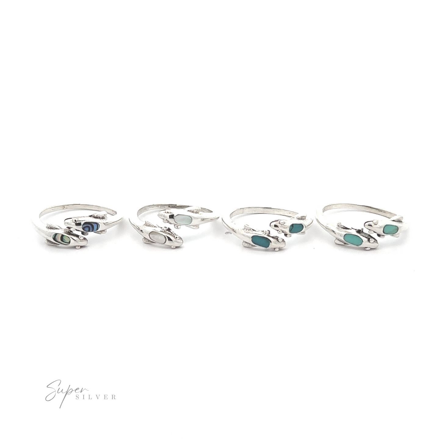 
                  
                    Four Dainty Inlaid Dolphin Rings with varying shades of blue and green gemstone inlays, displayed on a white background.
                  
                