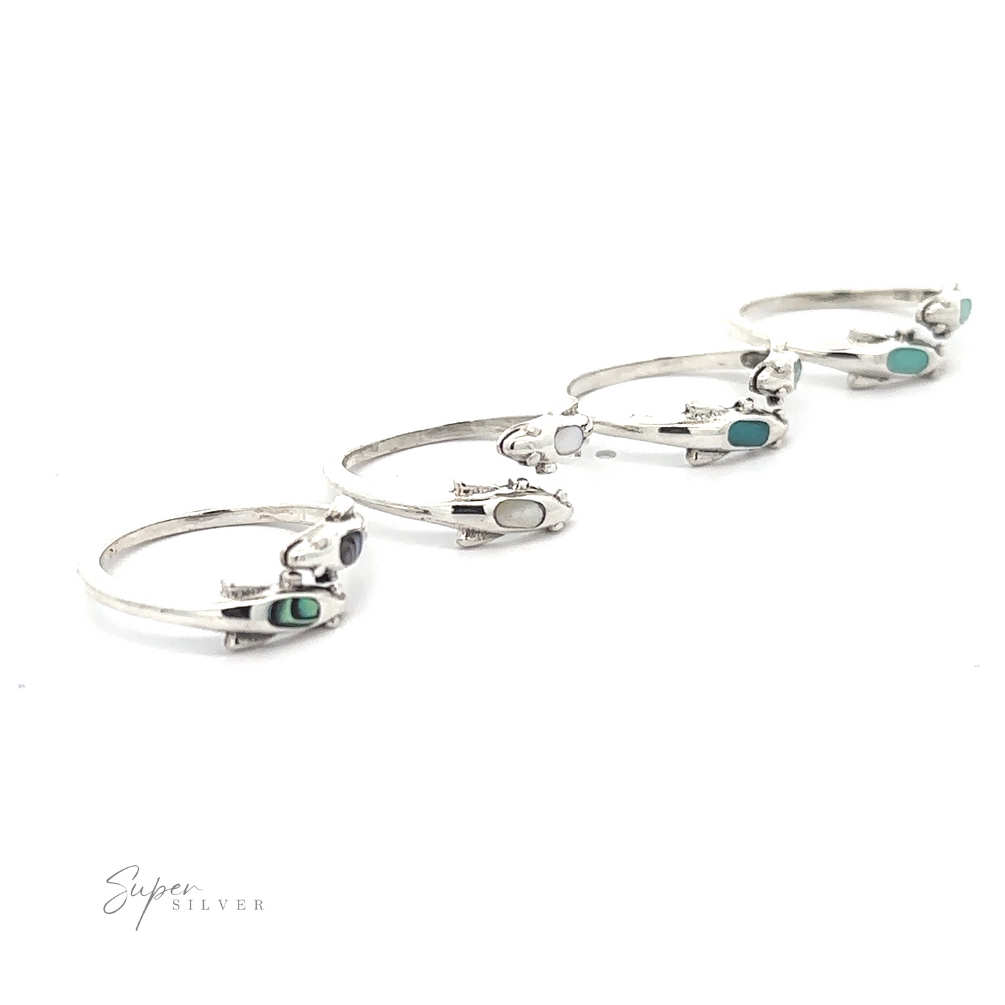 A collection of four sterling silver rings with turquoise accents, including a Dainty Inlaid Dolphin Ring, displayed on a white background.