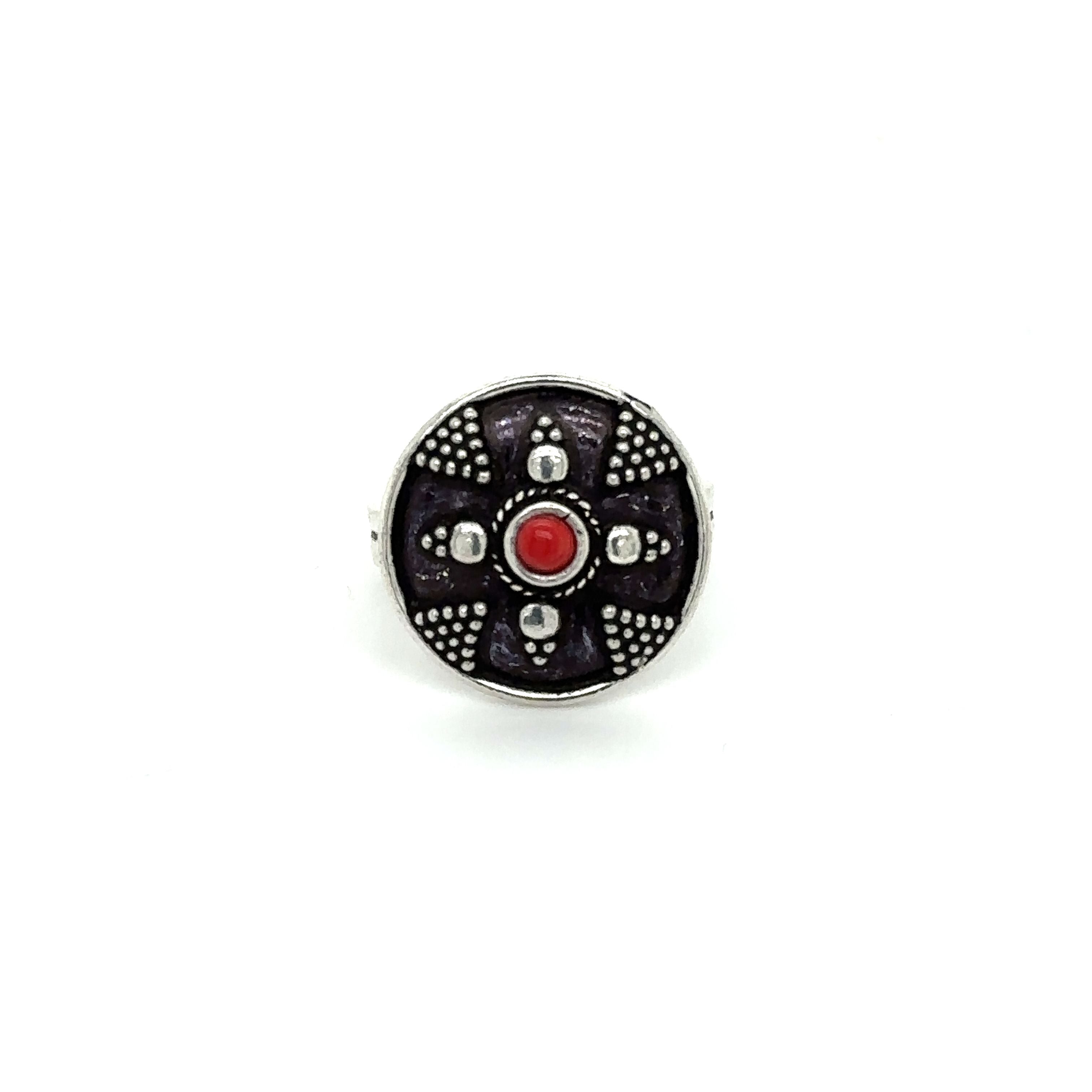 A Stunning Tibetan-Style Ring with a red stone in the center.