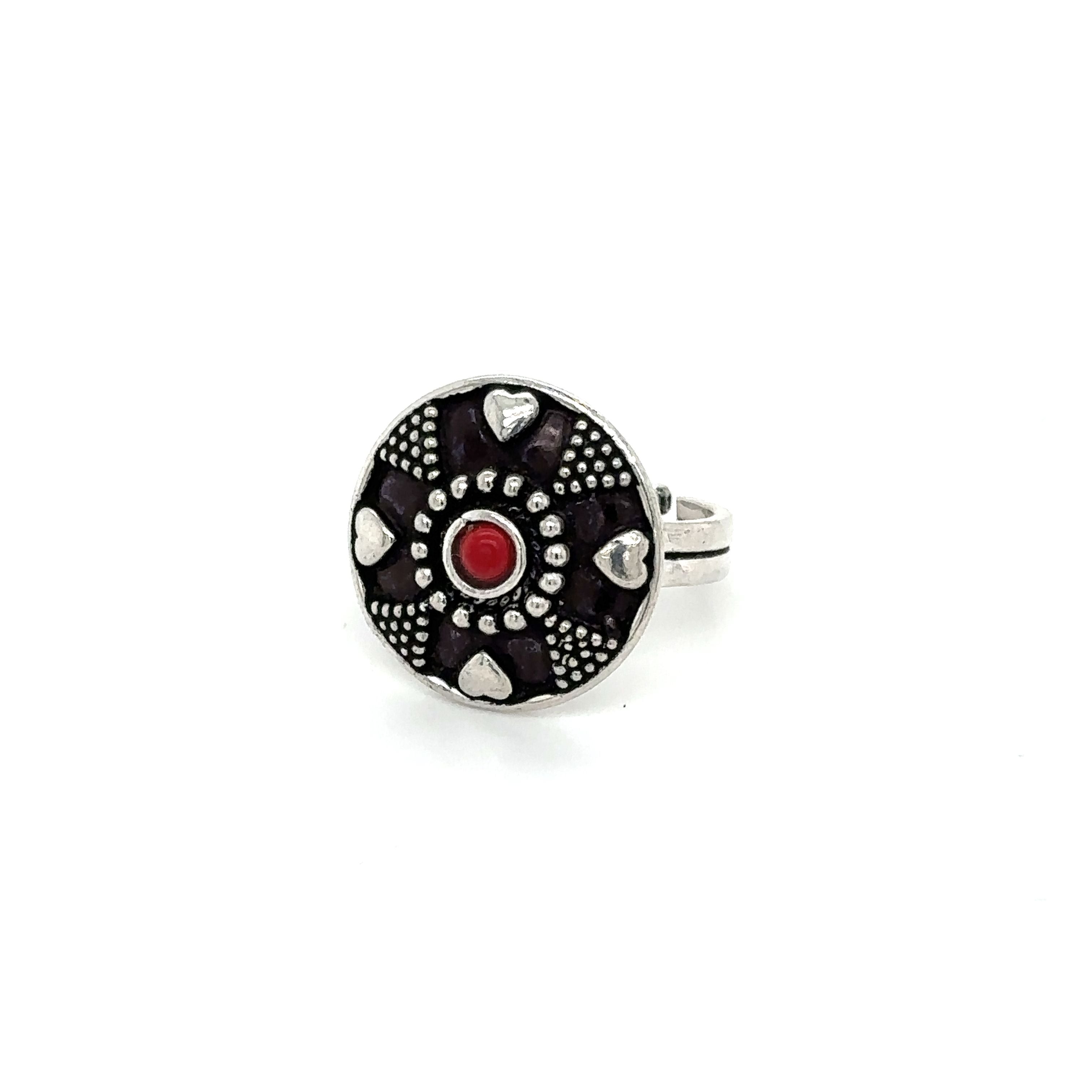 A stunning Tibetan-style ring adorned with a red stone.