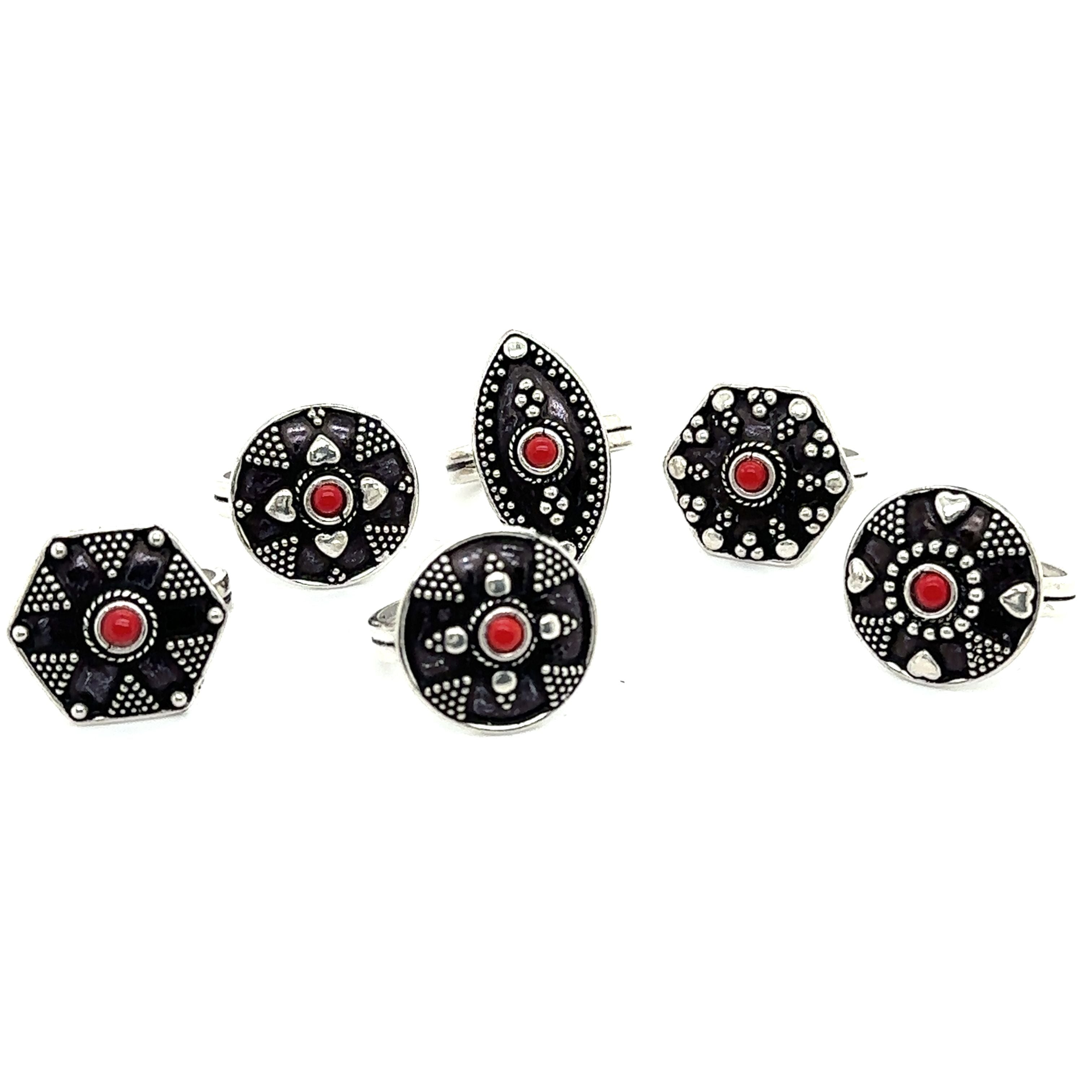 A stunning set of Tibetan-Style Rings with Small Stones adorned with vibrant red and black stones.