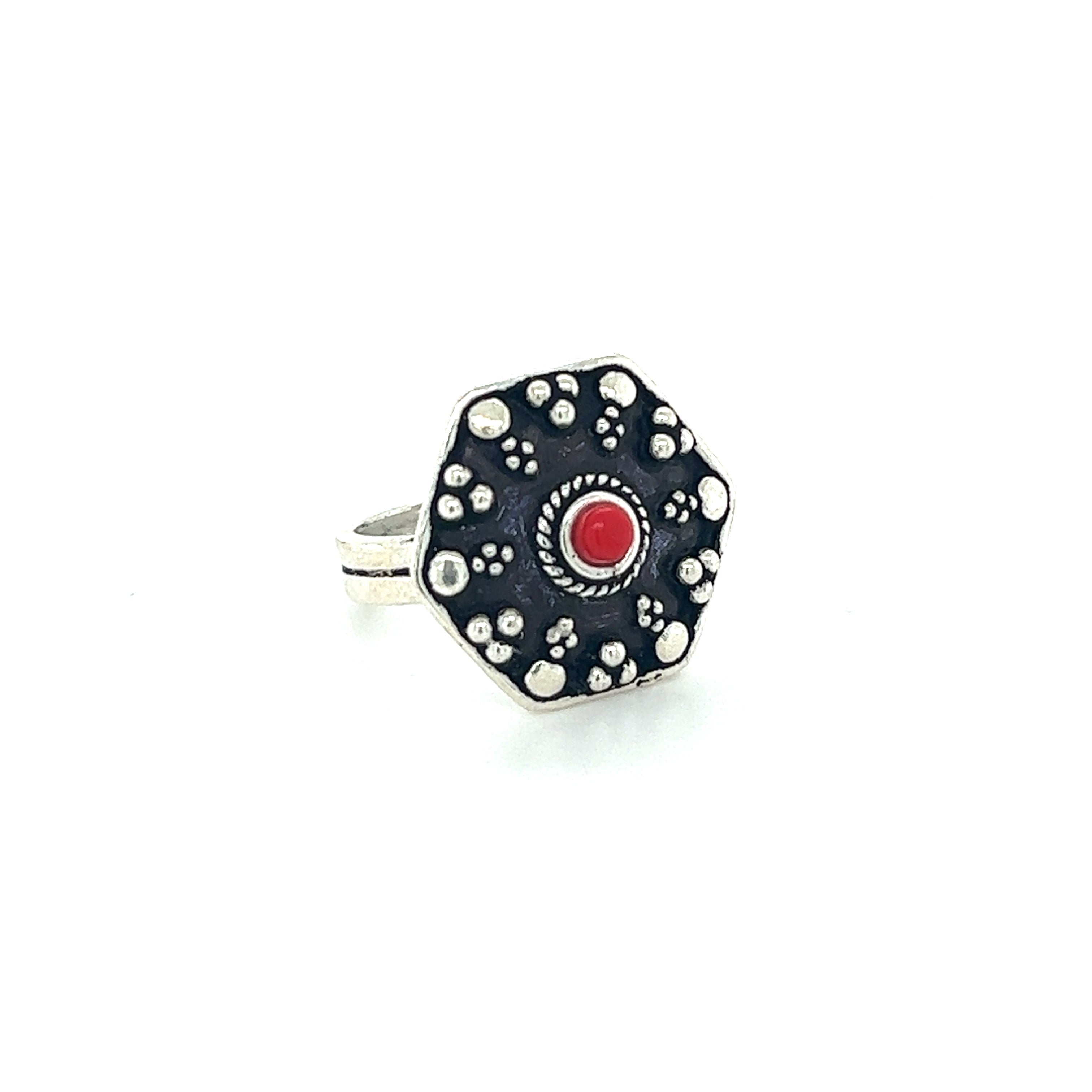 A stunning Tibetan-Style Rings with Small Stones with a silver band and a mesmerizing red stone.