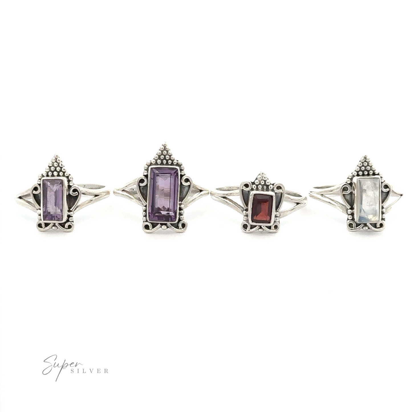 Four Bohemian Princess Rings with rectangular gemstones, including an amethyst and moonstone, in various colors displayed in a line on a white background. The gemstones are purple, dark purple, red, and clear. Perfect for adding a touch of Boho-style princess charm to any outfit.