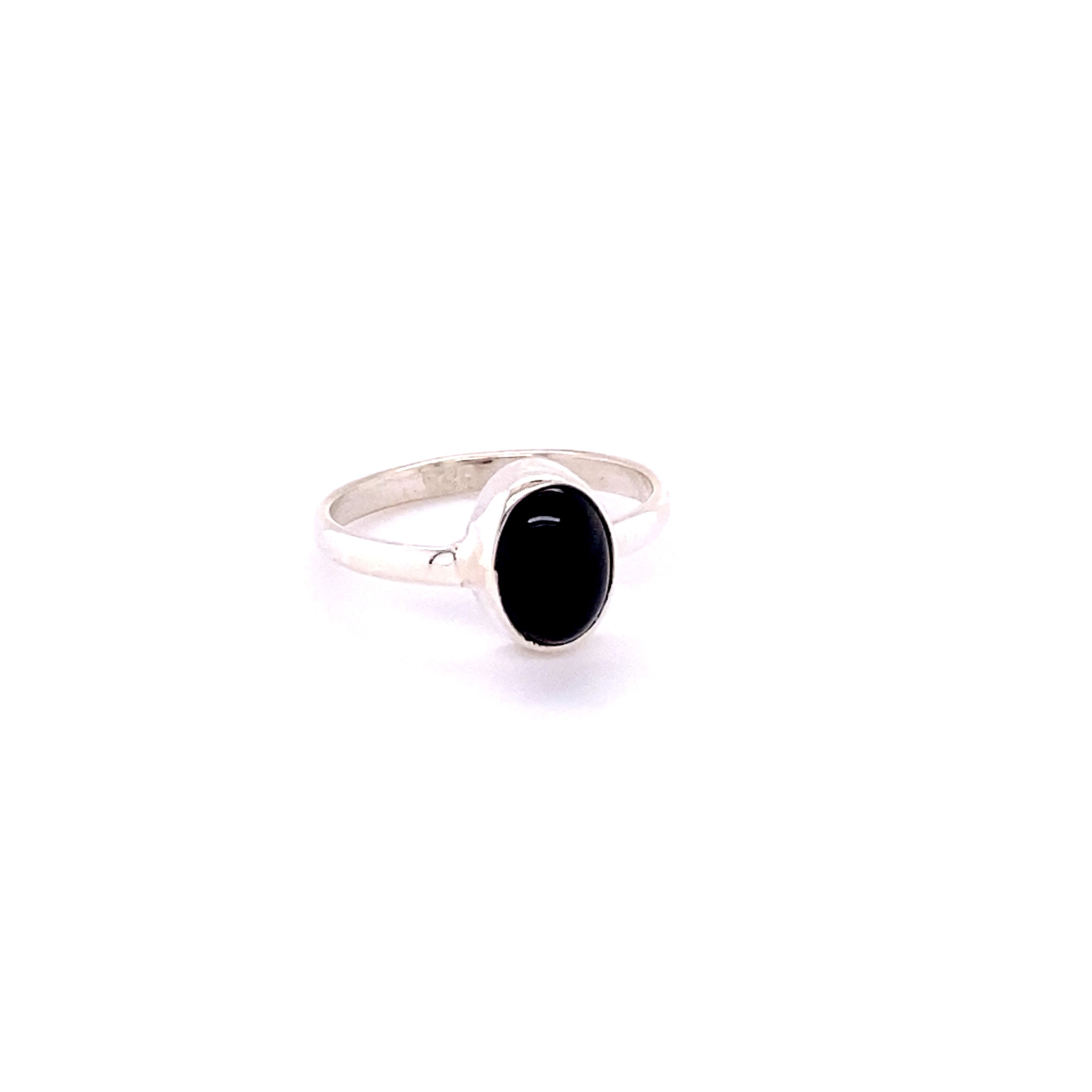 A Simple Oval Natural Gemstone Ring with an oval black stone set in a simple bezel, isolated on a white background.