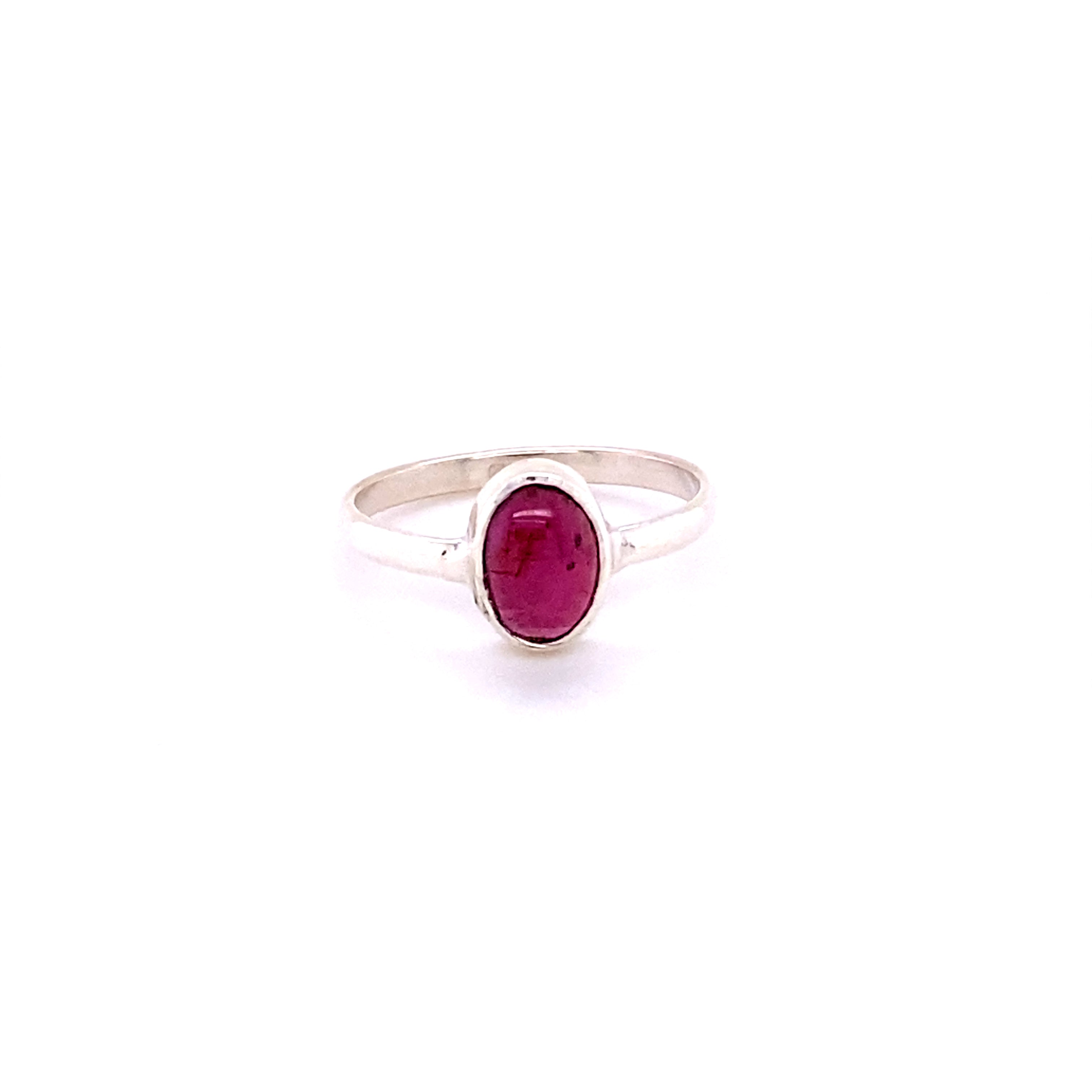 Simple Oval Natural Gemstone Ring with an oval-shaped, deep pink gemstone, centered on a plain band, isolated on a white background.