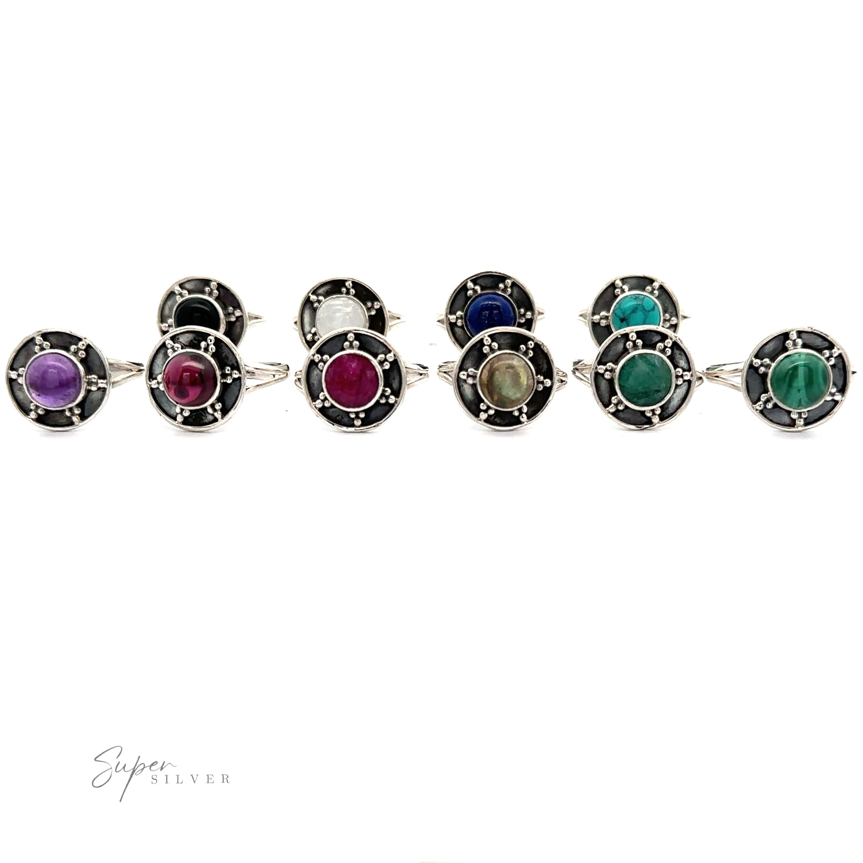 A row of ten Gemstone Rings With Unique Oxidized Design with various colored stones, including purple, red, blue, green, and white, set in decorative sterling silver bands. The background is white. The logo "Super Silver" is visible.
