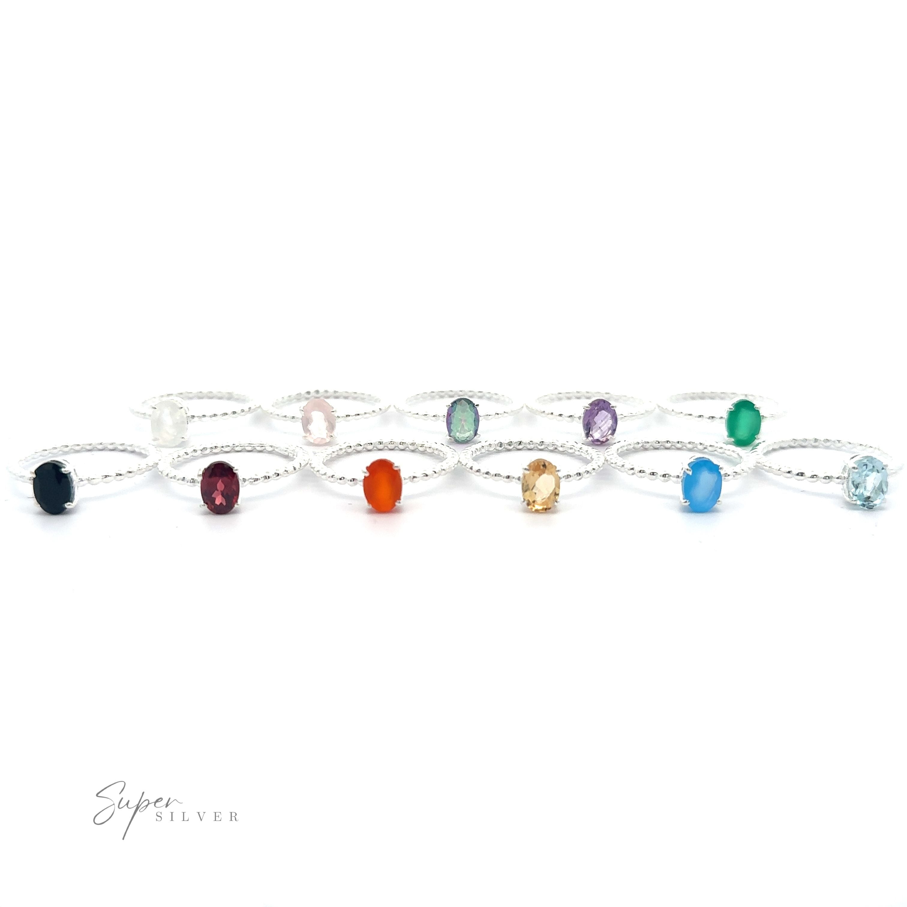 A collection of sterling silver bracelets with stunning oval gemstone ring with beaded band accents, displayed in a row on a white background.
