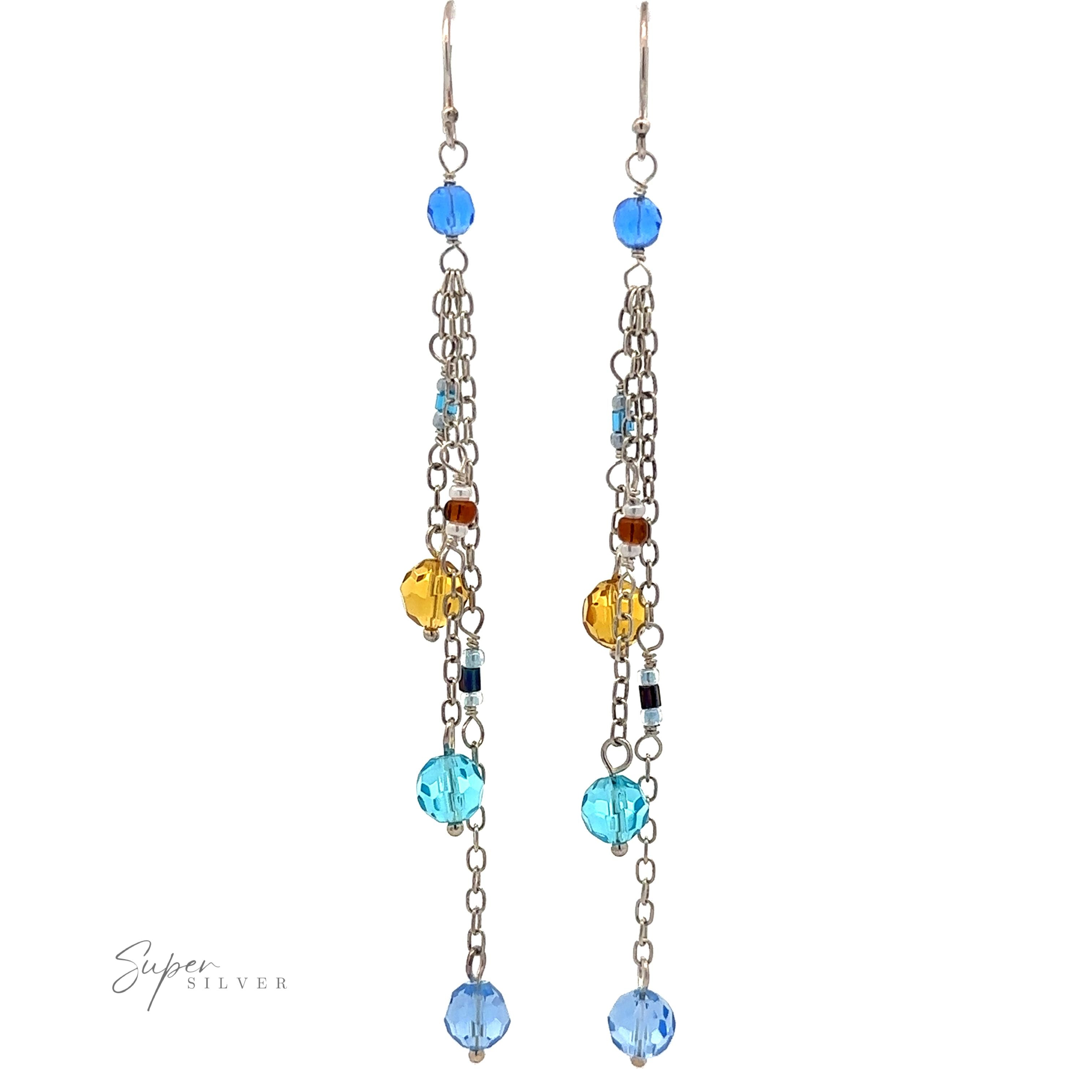 A pair of Multicolor Beaded Dangle Earrings with long chains featuring multicolored beads in blue, yellow, and brown. A small "Super Silver" logo is on the bottom left.
