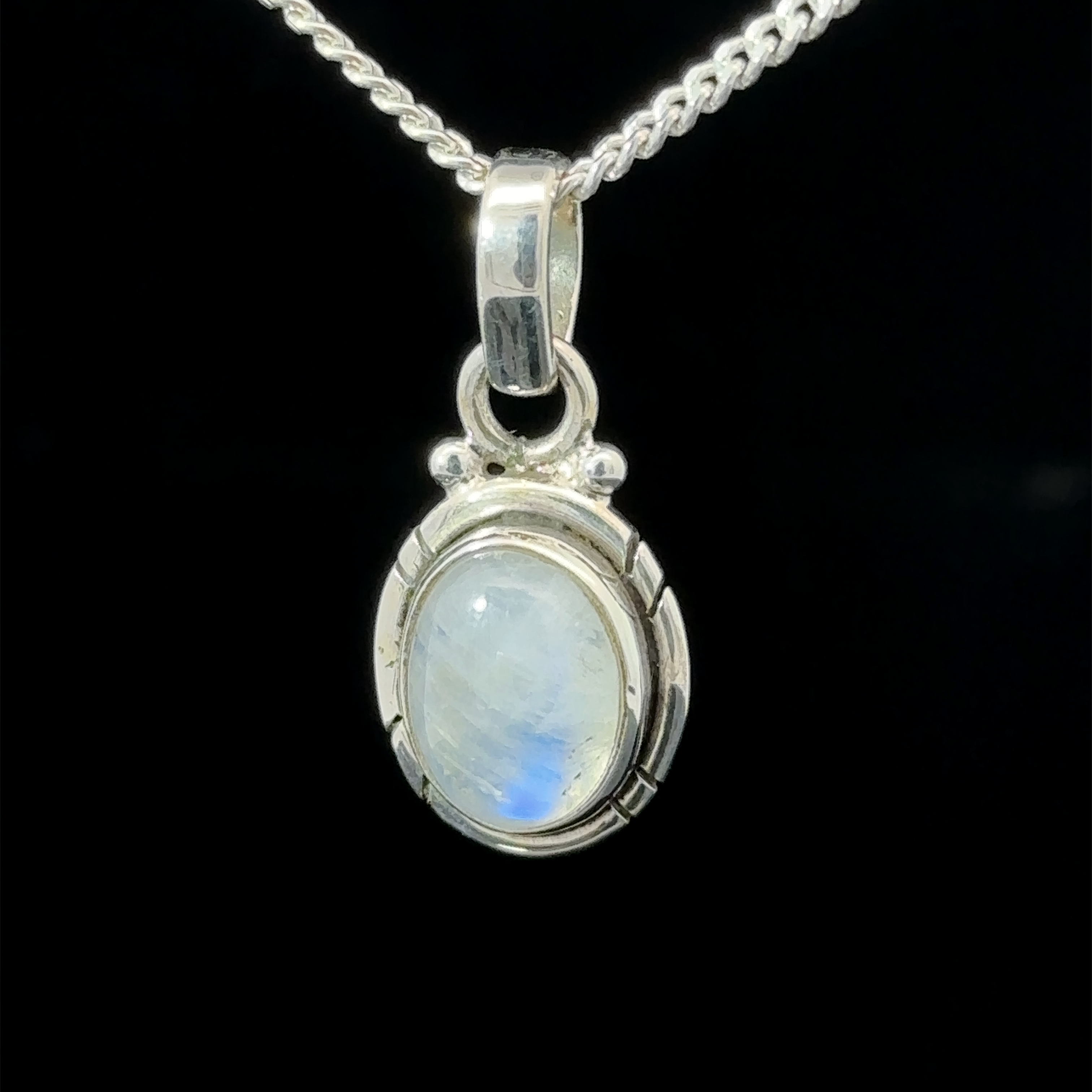 A Simple And Elegant Oval Moonstone Pendant featuring an oval-shaped moonstone set in a decorative bezel.