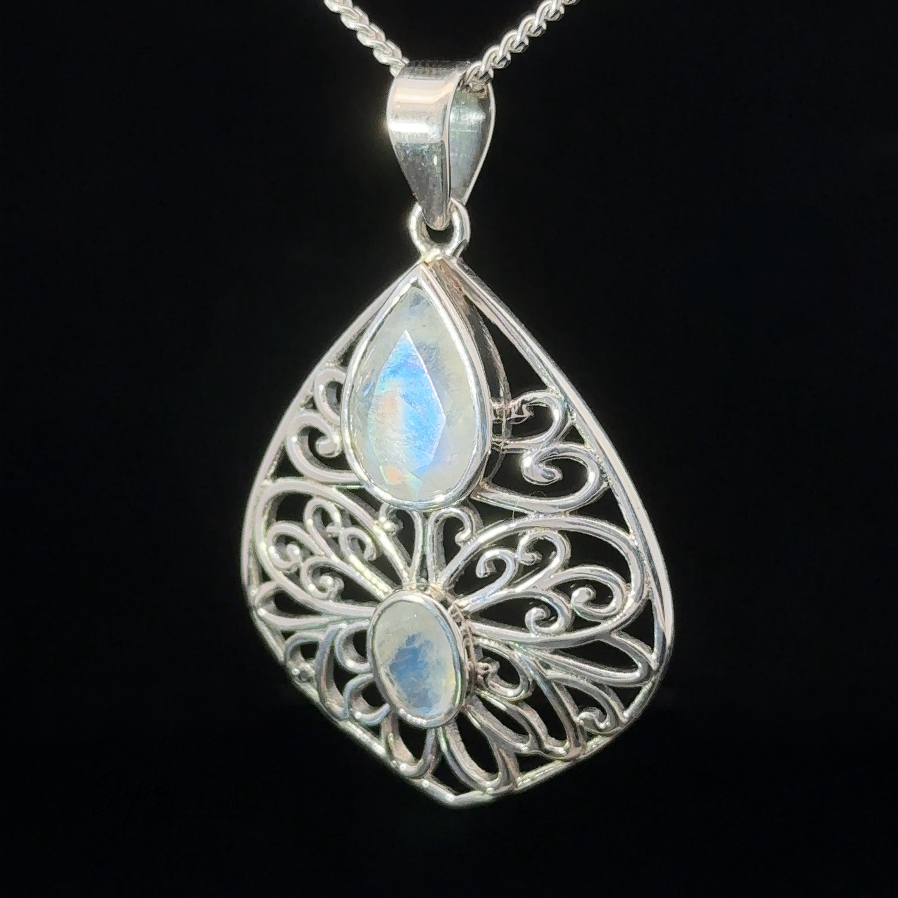 A Teardrop Filigree Gemstone Pendants with intricate filigree design, featuring two pear-shaped moonstones, one larger above and one smaller below, suspended from a delicate silver chain.