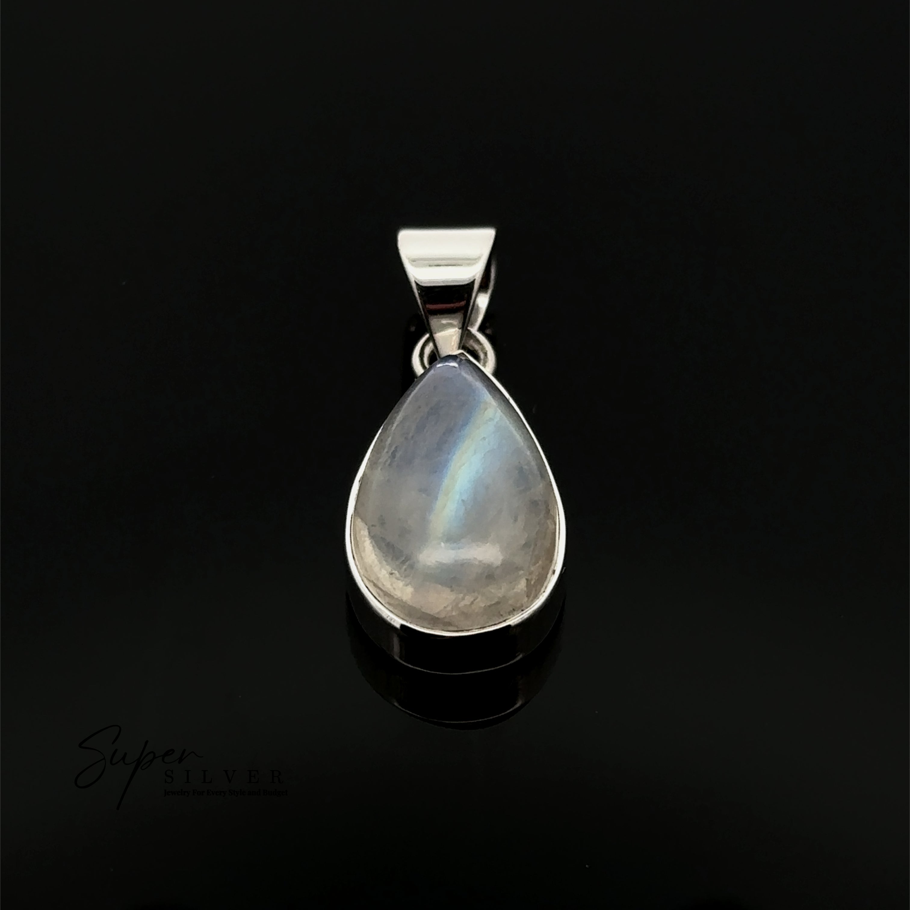 The Simple Teardrop Moonstone Pendant, set in sterling silver and displayed on a black background, radiates mystical energy.