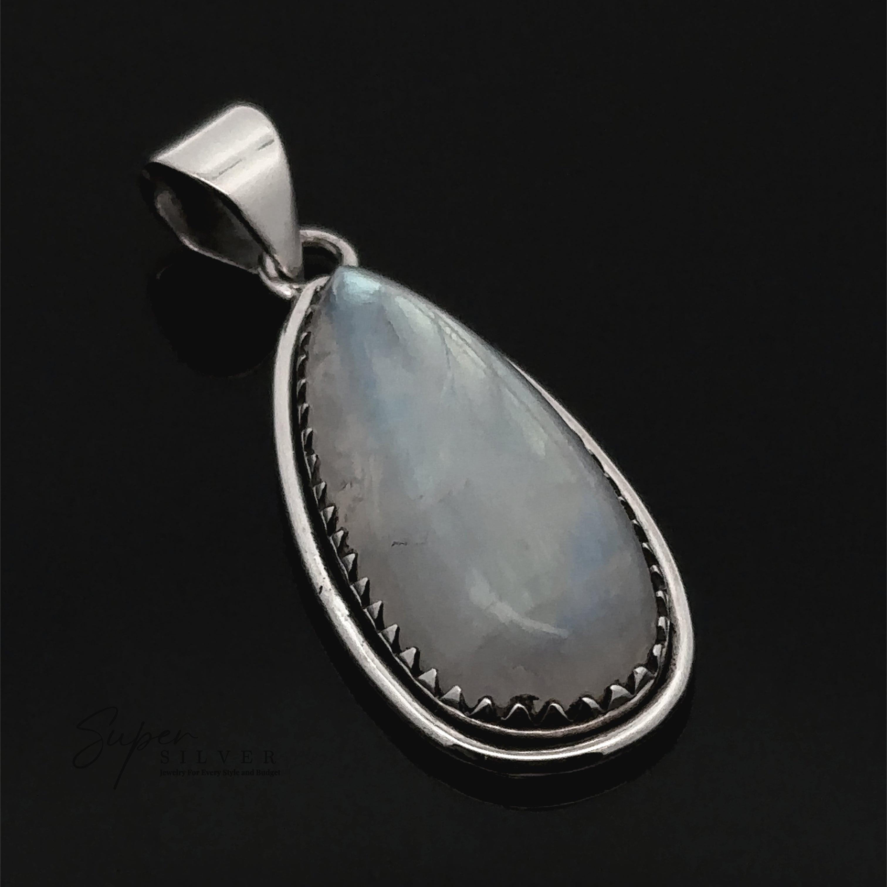 The Teardrop Moonstone Pendant features a moonstone set in a sterling silver bezel with scalloped boho details, shown against a black background.