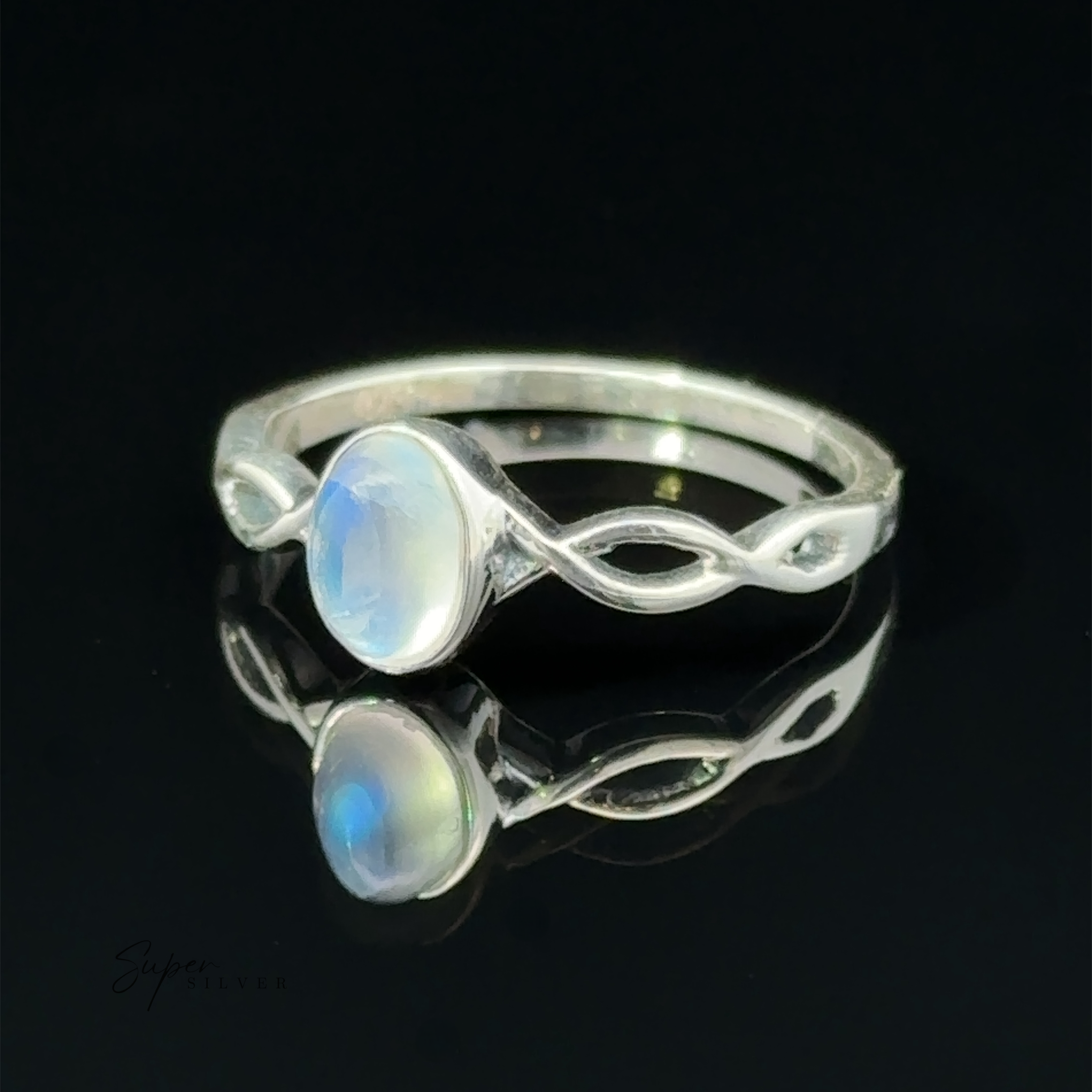 Dainty Oval Gemstone Ring with Twisted Band with a reflective black surface.