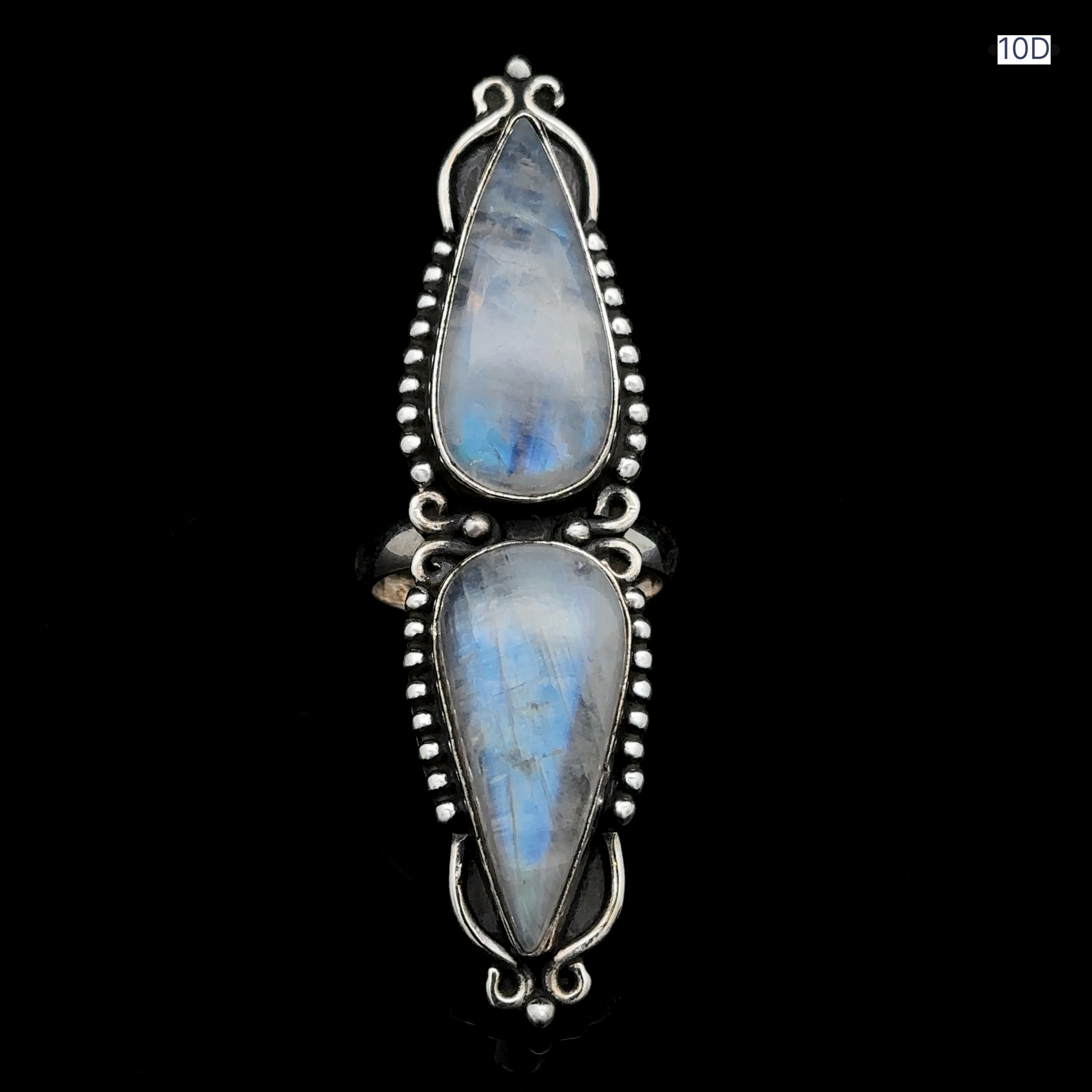 Introducing the Long Double Teardrop Moonstone Ring in sterling silver, showcasing two vertically set teardrop-shaped moonstones and adorned with detailed beadwork on a black background.