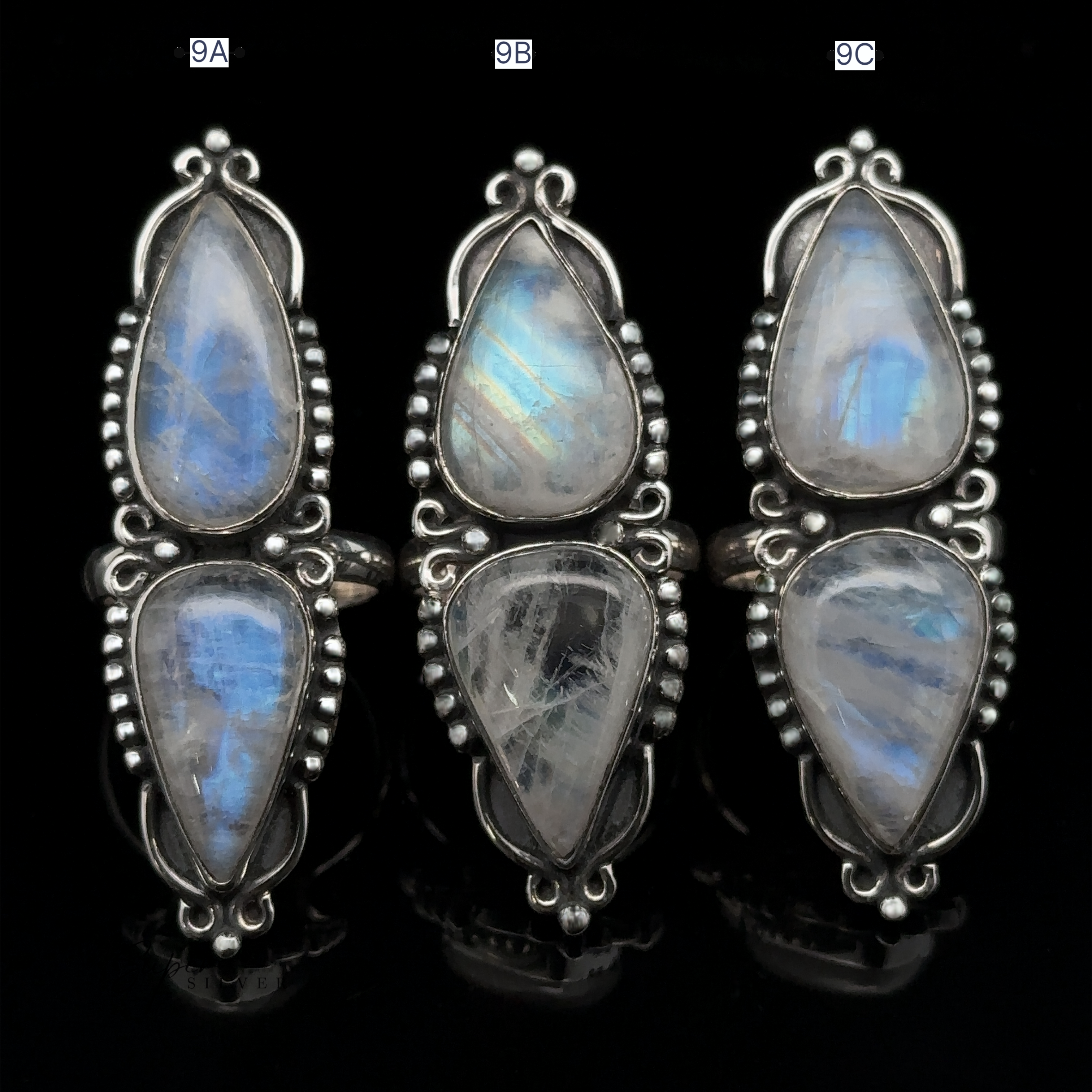 Three sterling silver Long Double Teardrop Moonstone Rings, each labeled 9A, 9B, and 9C. The stones display iridescent blue and white hues, making each one a striking statement ring.