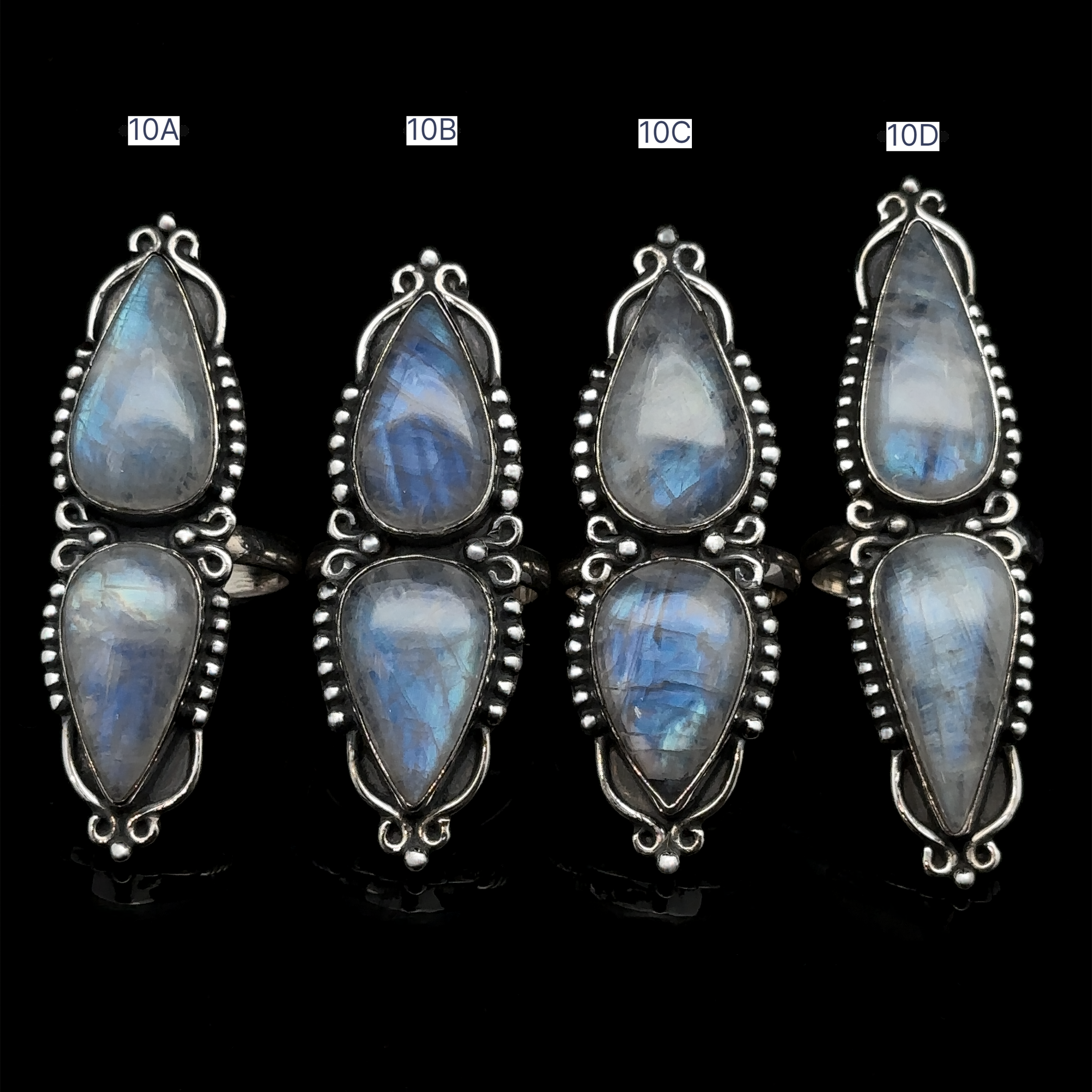 Four pairs of Long Double Teardrop Moonstone Rings, labeled 10A, 10B, 10C, and 10D, displayed vertically against a black background. Each statement ring catches the light beautifully.