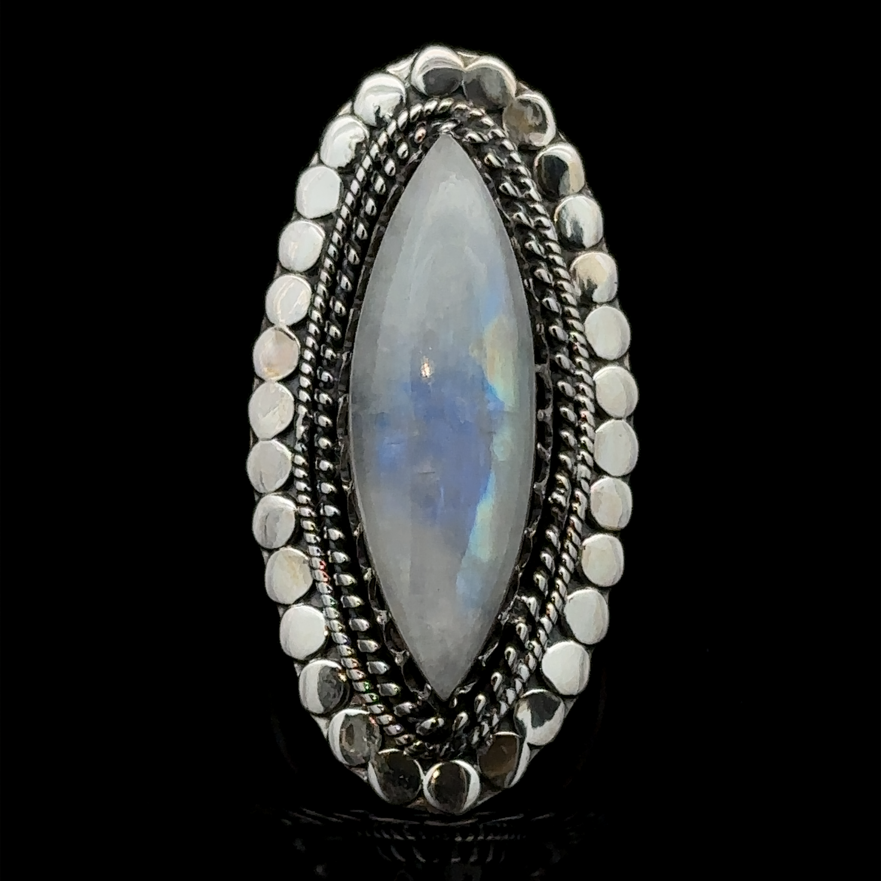 A Statement Marquise Shaped Gemstone Ring set in an ornate silver ring with a beaded border, displayed on a black background, epitomizes Bohemian Jewelry.