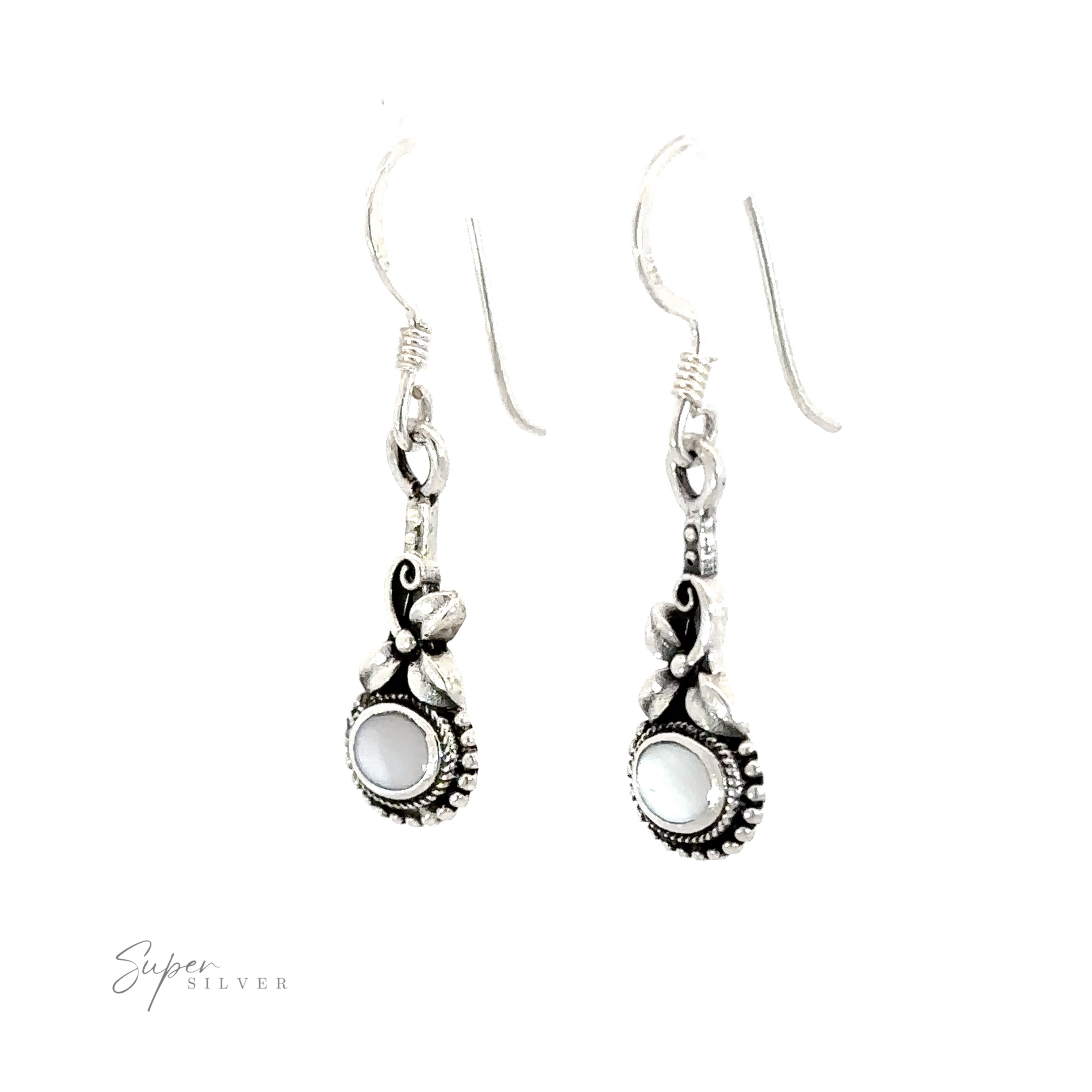 A pair of Inlaid Flower Earrings with Oval Stone, exuding vintage charm.