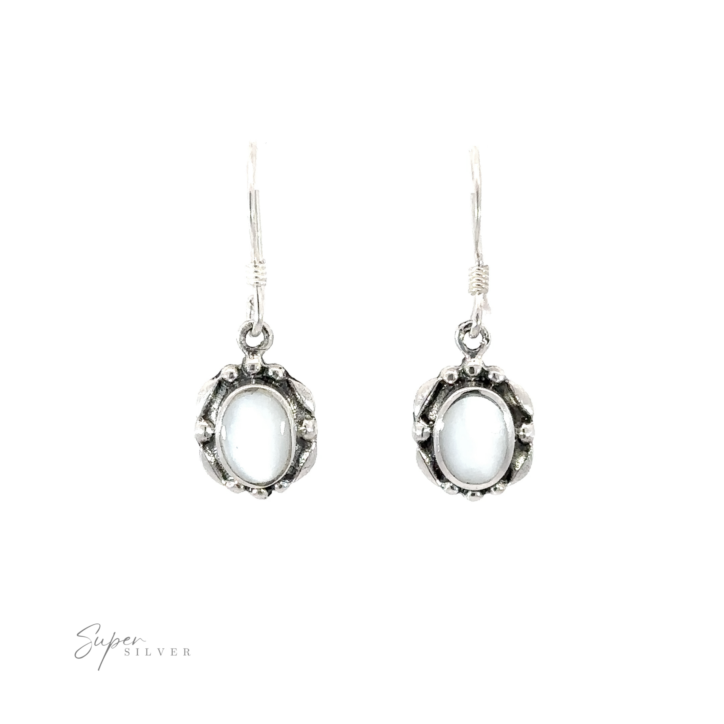 A pair of Oval Inlaid Stone Earrings with an inlaid white stone.