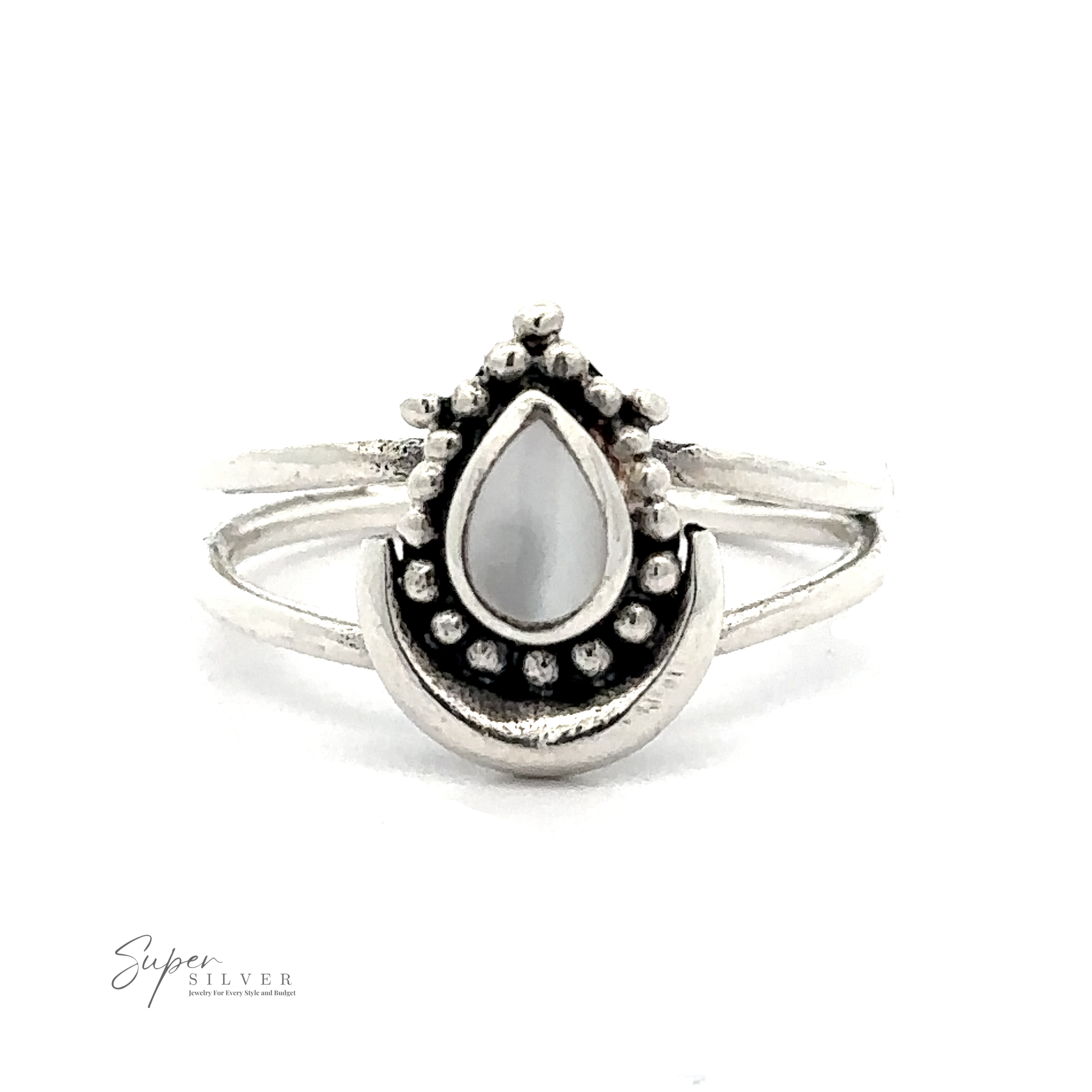 A Teardrop Ring With Inlaid Stone and Crescent Moon featuring a teardrop-shaped white stone in the center, surrounded by small decorative metal beads, with a minimalist split band design. This bohemian ring is adorned with Bali-inspired silverwork, adding an exotic touch to its elegant simplicity.