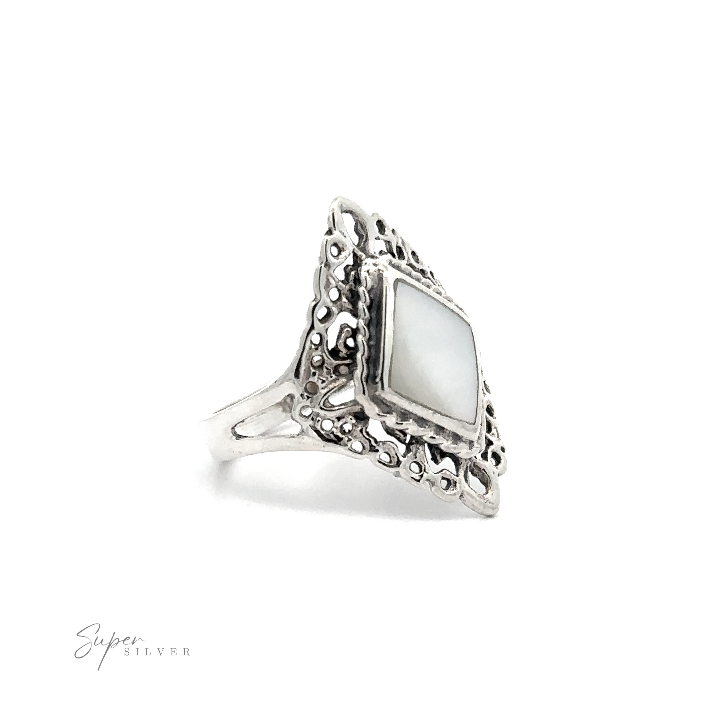 A diamond-shaped filigree mother of pearl ring with inlaid stones on a white background.