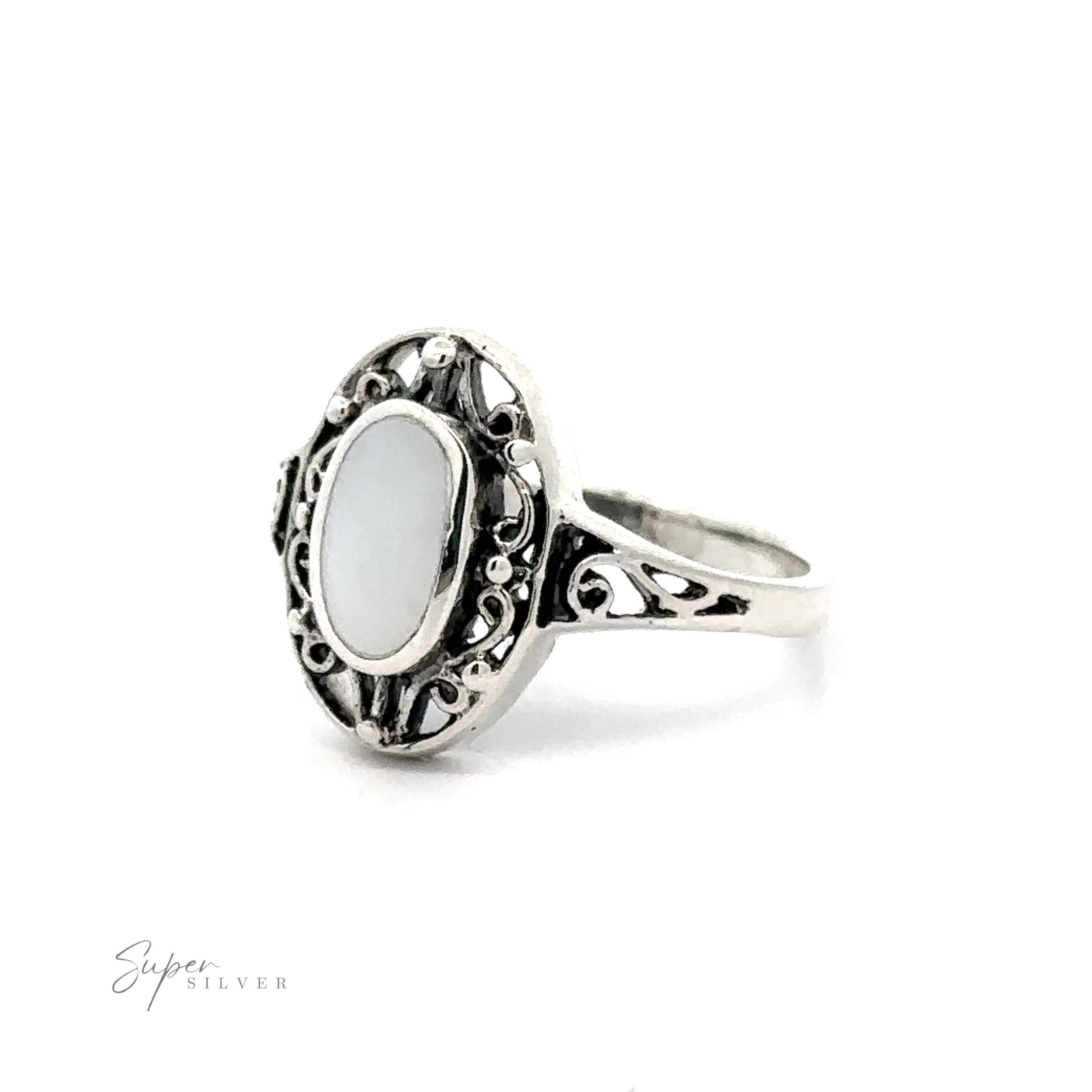 An ornate sterling silver ring with an Oval Inlay Stone with Swirl Filigree Border.