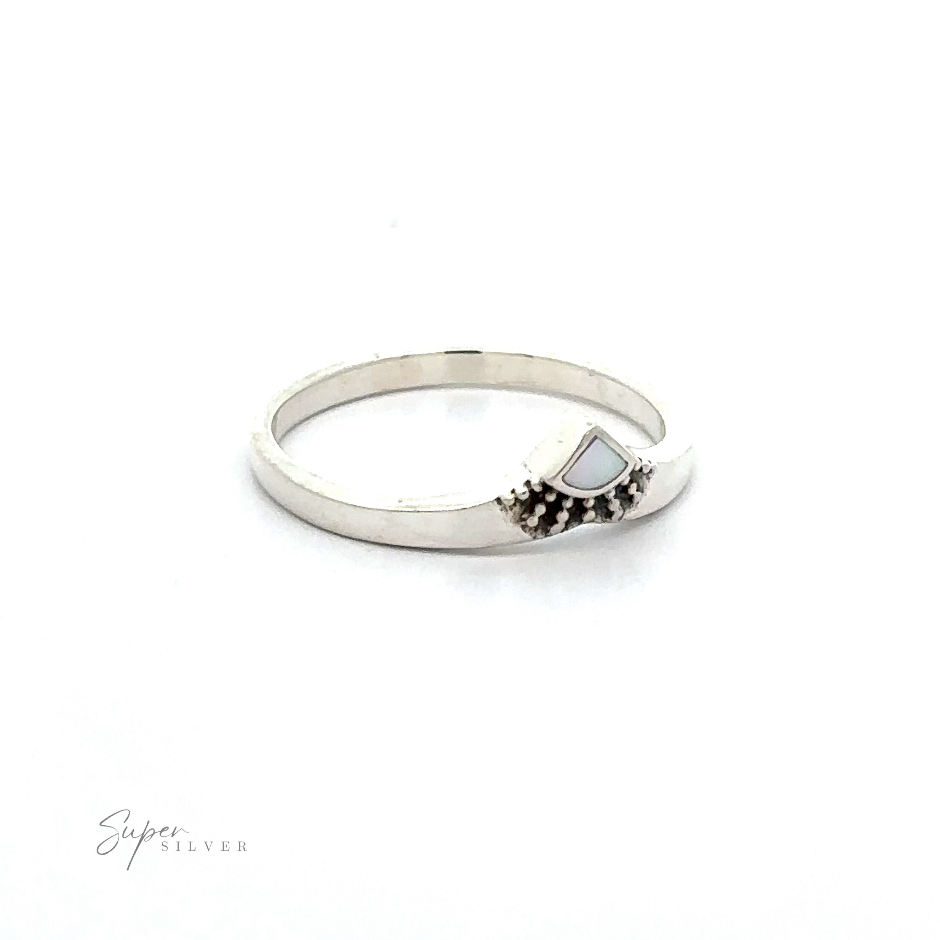 A Dainty Chevron Bali Style Inlay Ring with a white mother of pearl stone in the middle.