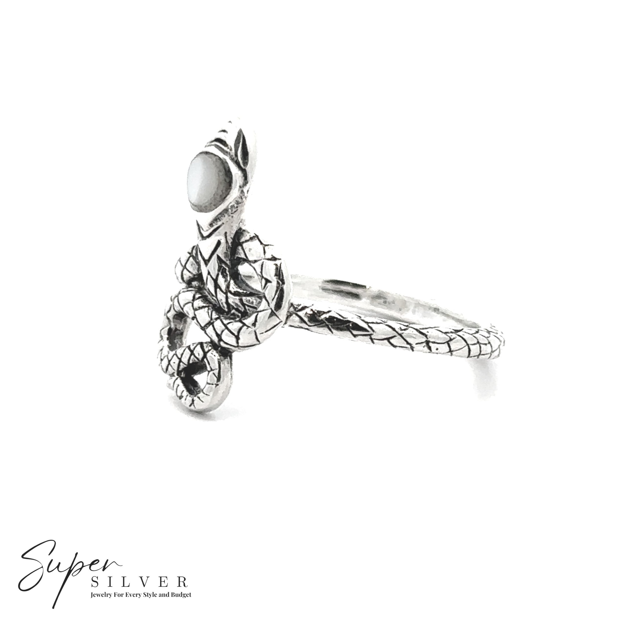 The Coiled Snake Ring with Inlaid Stone features a sterling silver serpent design, detailed scales, and a round white stone on its head. The “Super Silver” logo appears in the bottom left—transformation jewelry at its finest.
