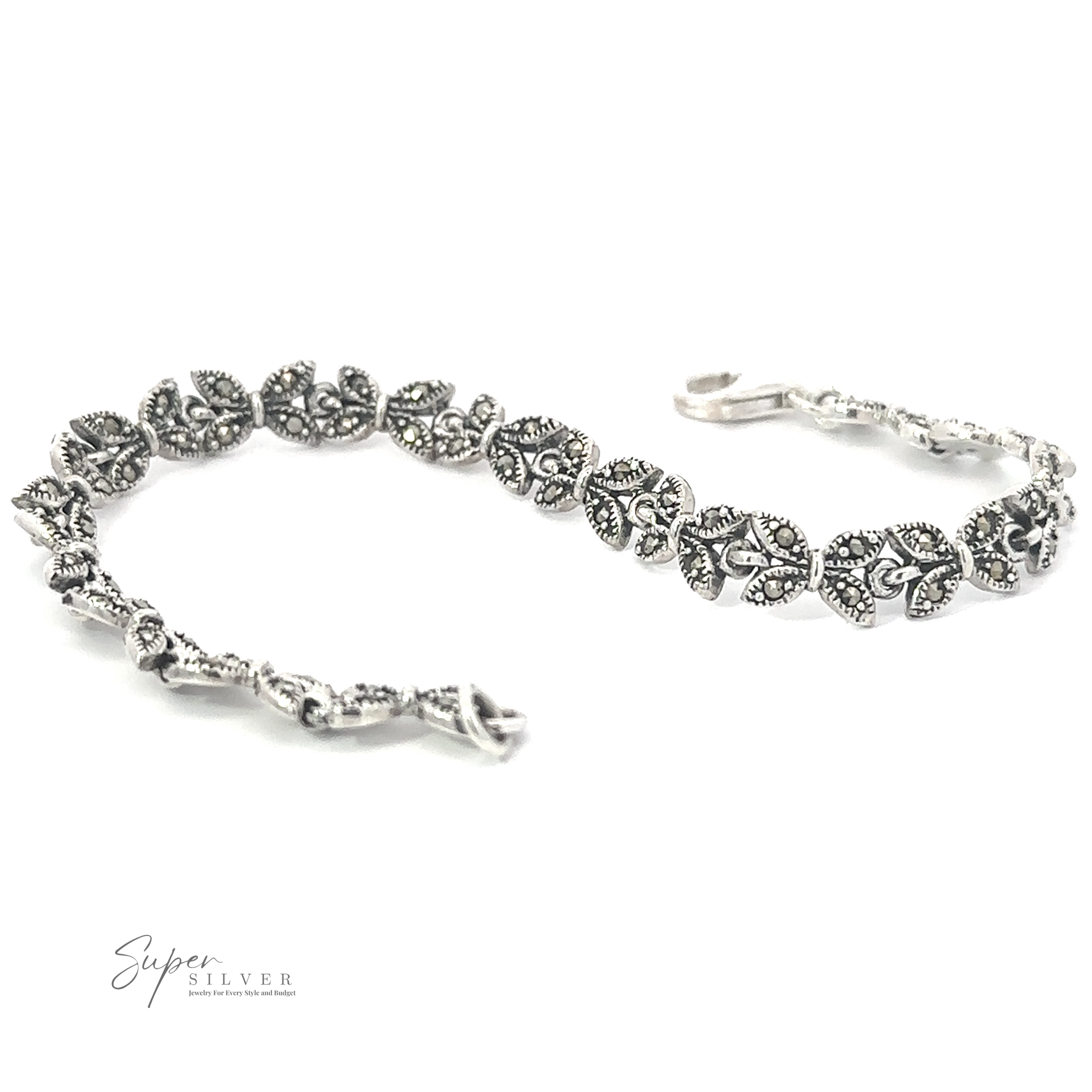A Marcasite Butterfly Bracelet featuring intricate leaf designs with detailed floral patterns, reminiscent of the Art Deco era. Crafted from .925 sterling silver, it has a touch of vintage charm. A small logo, "Super Silver," is visible in the bottom left corner.