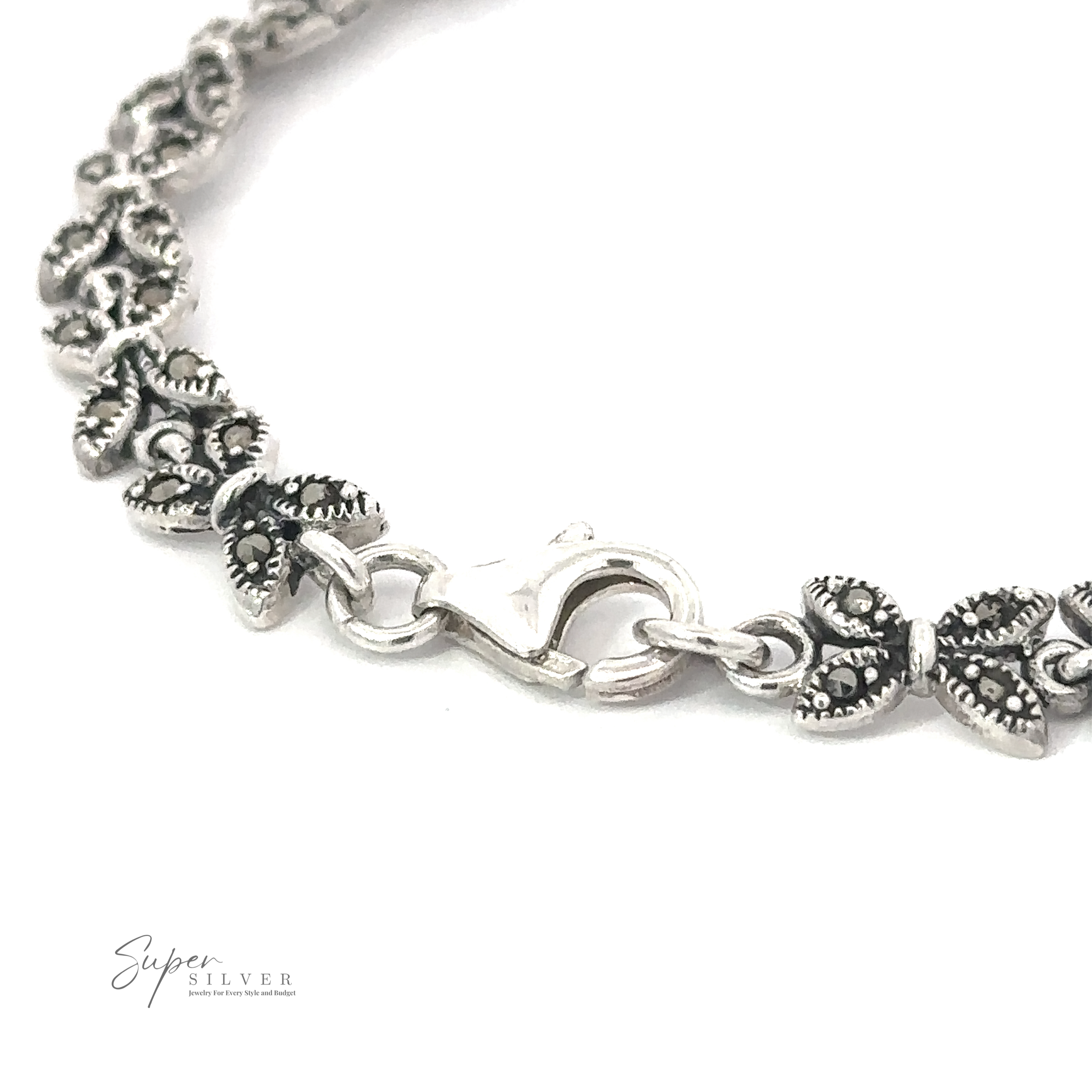 A close-up of a Marcasite Butterfly Bracelet with ornate floral designs and a lobster clasp. The logo for "Super Silver" is visible in the bottom left corner, emphasizing its Art Deco era style.