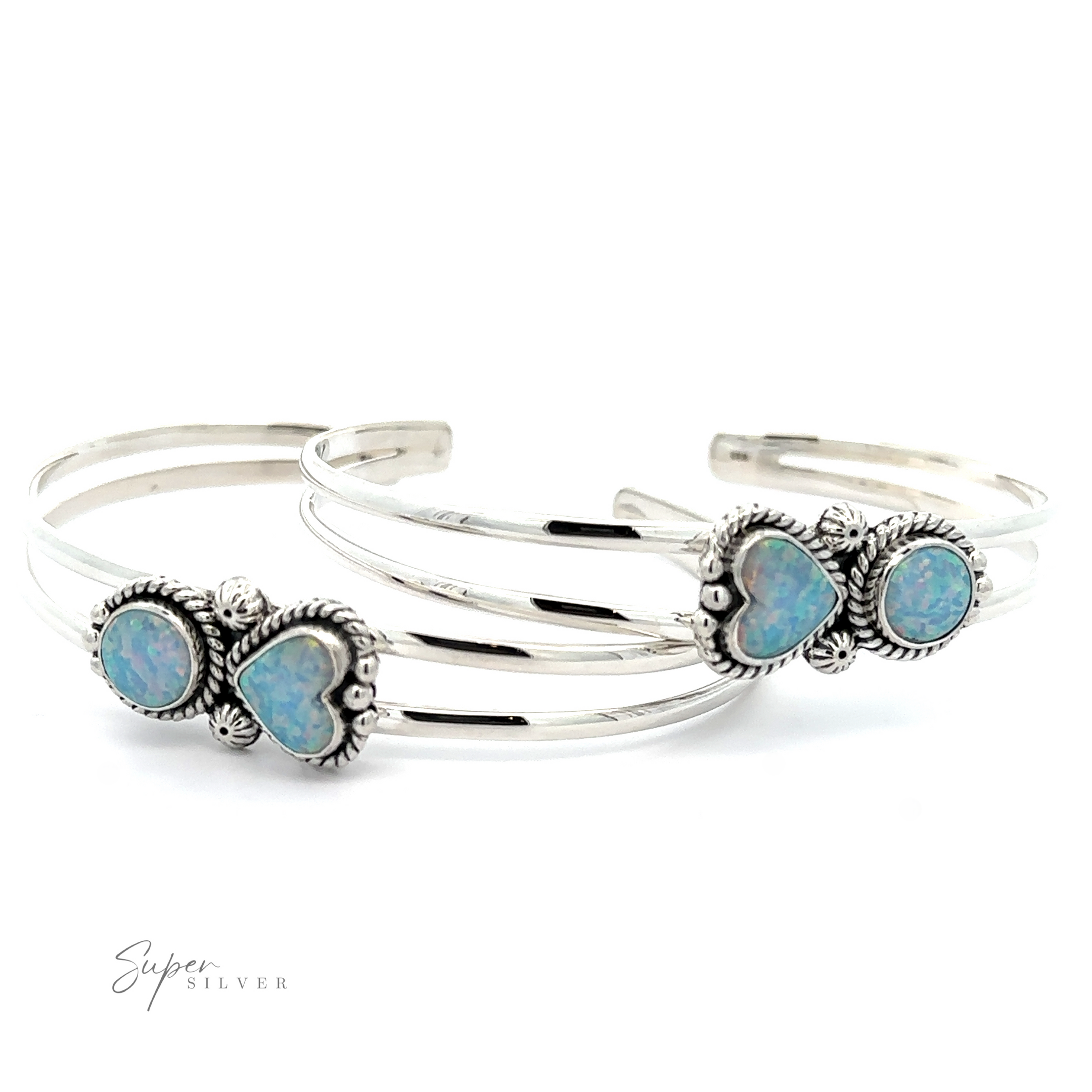 Two Opal Heart And Circle Cuff Bracelets featuring ornate heart-shaped opal gemstone settings. Romantic jewelry text reading "Super Silver" graces the bottom left corner.