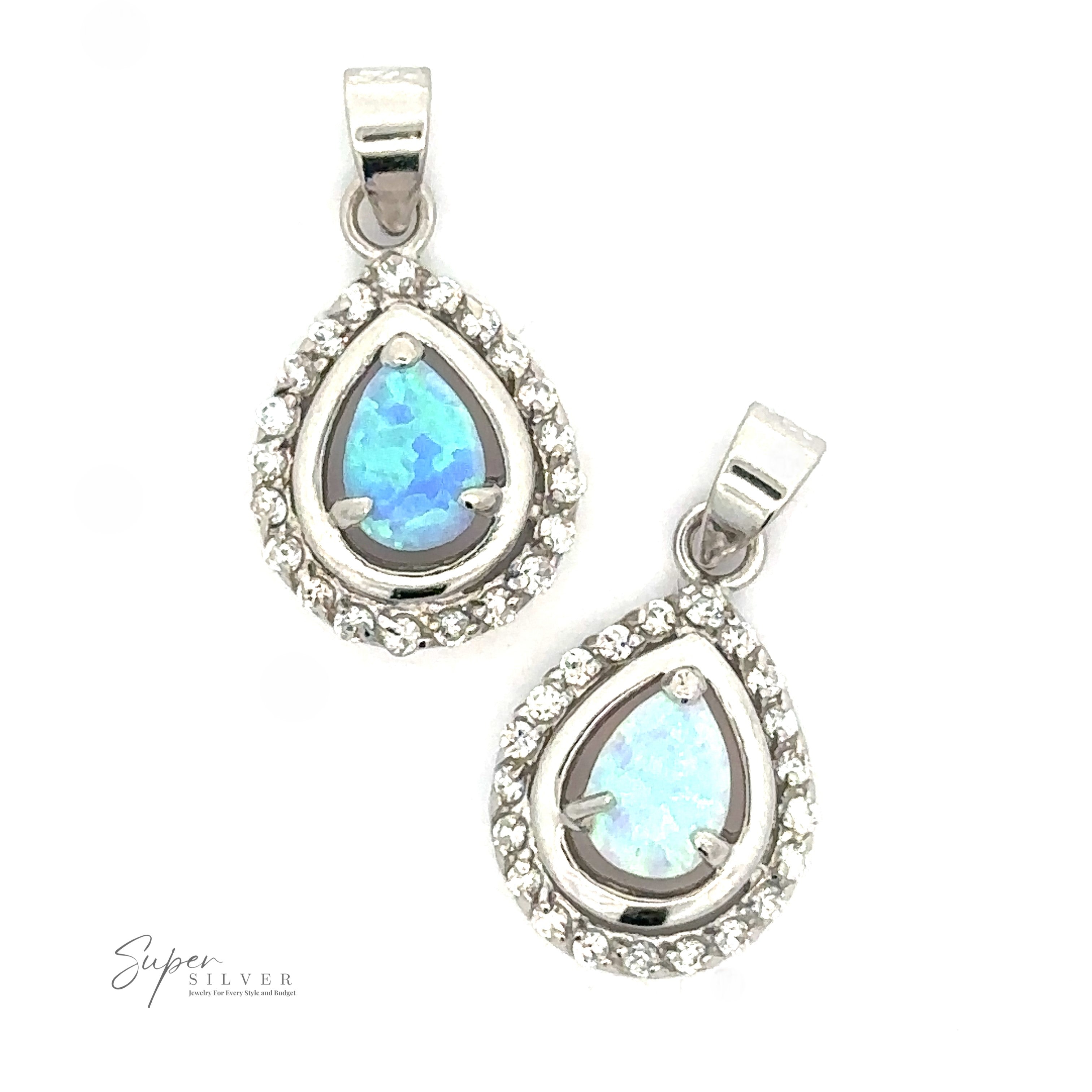 Two teardrop-shaped Opal Pendants with Cubic Zirconia featuring lab-created opal gemstones surrounded by small cubic zirconia stones, with a small logo at the bottom left reading "Super Silver".