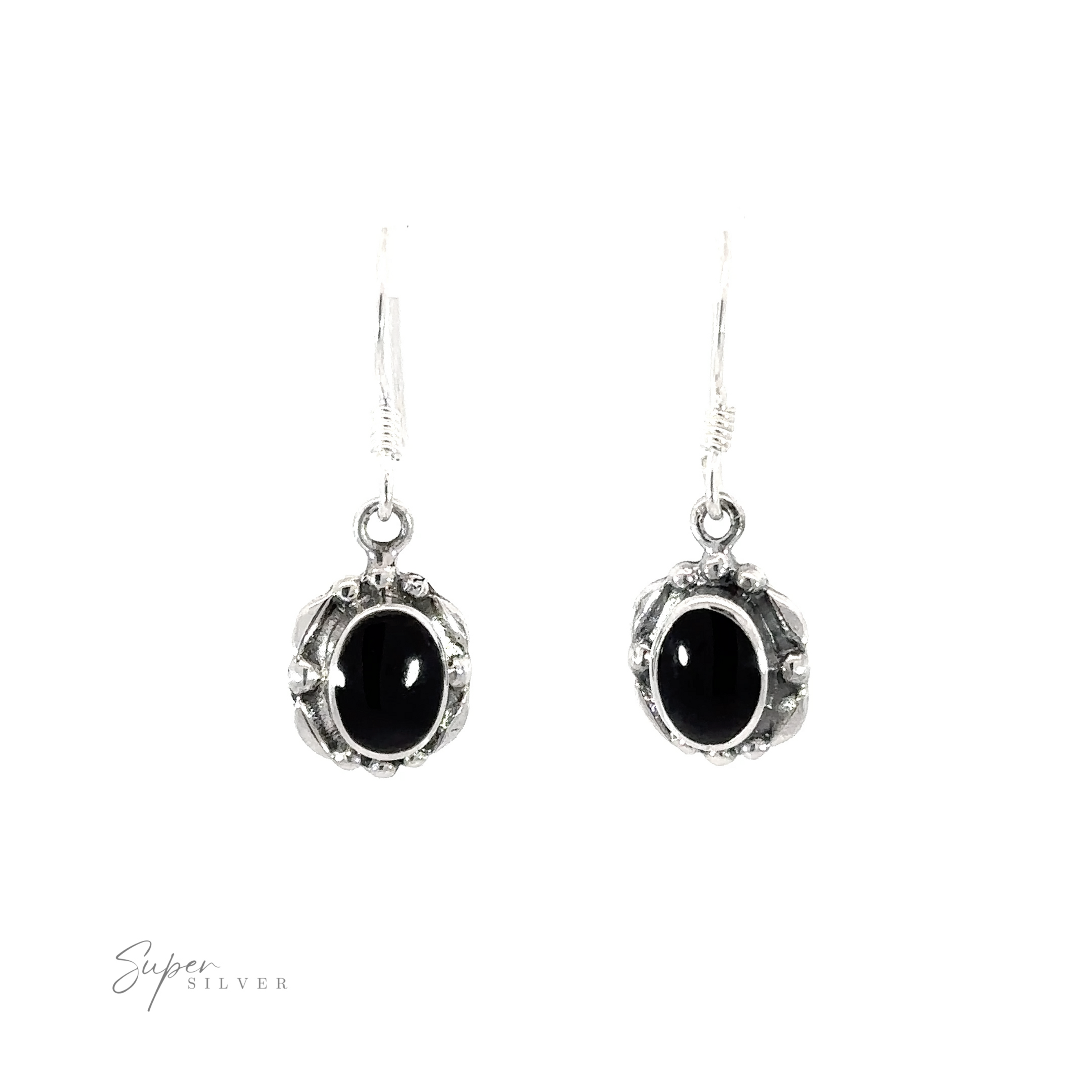 A pair of Oval Inlaid Stone Earrings with inlaid black onyx stones on a white background.