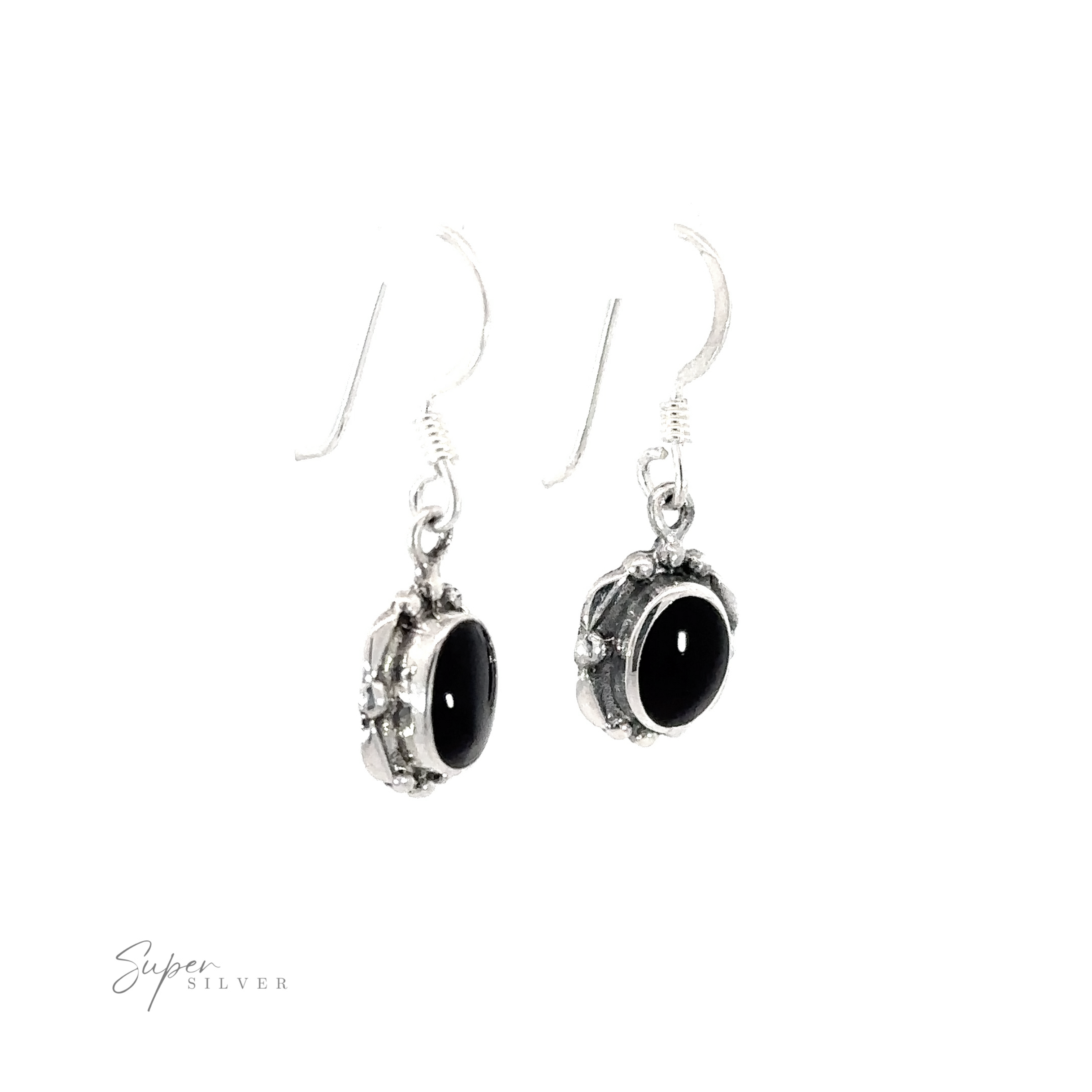 A pair of Oval Inlaid Stone Earrings with inlaid black onyx stones on a white background.