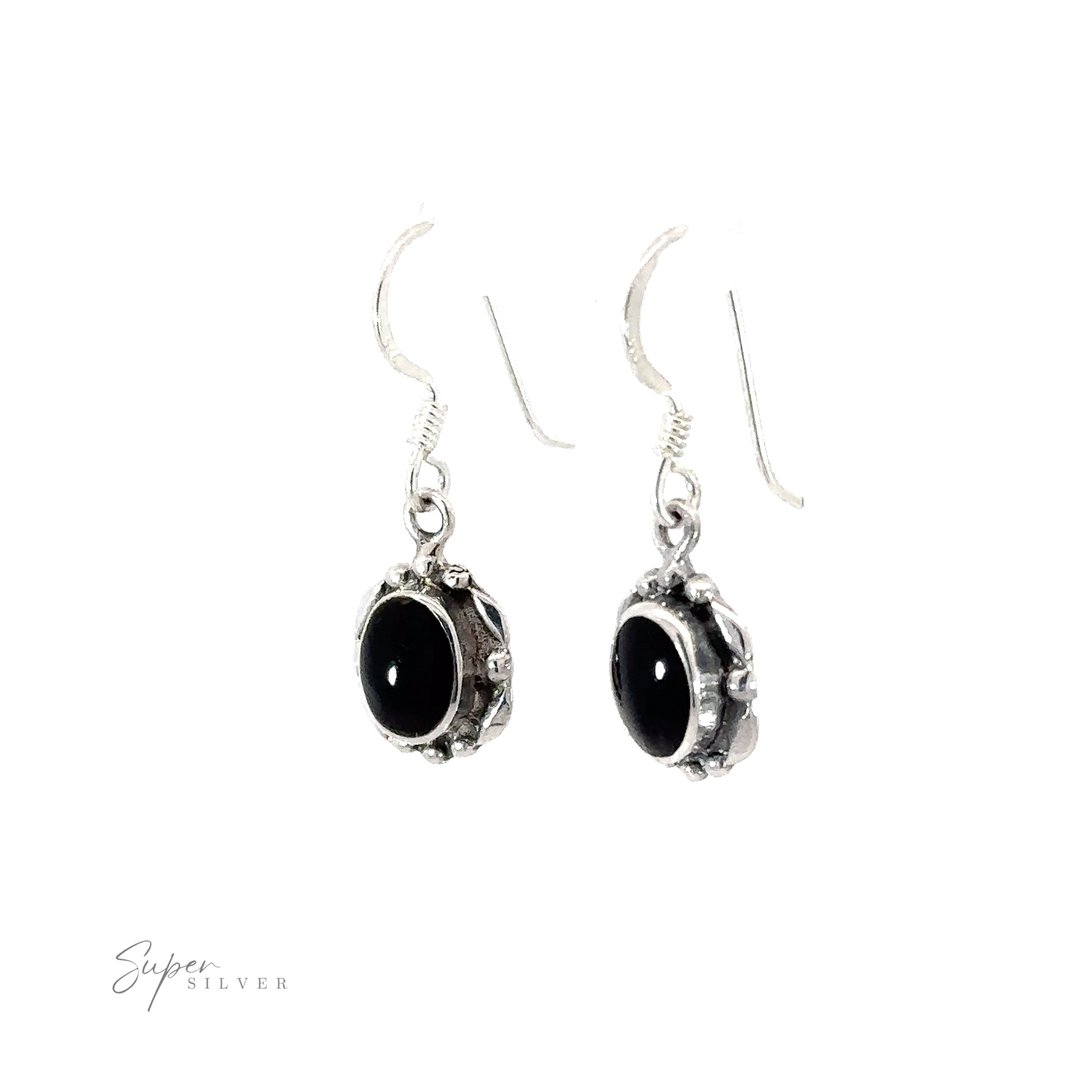 A pair of Oval Inlaid Stone Earrings with inlaid black onyx stones on a white background.