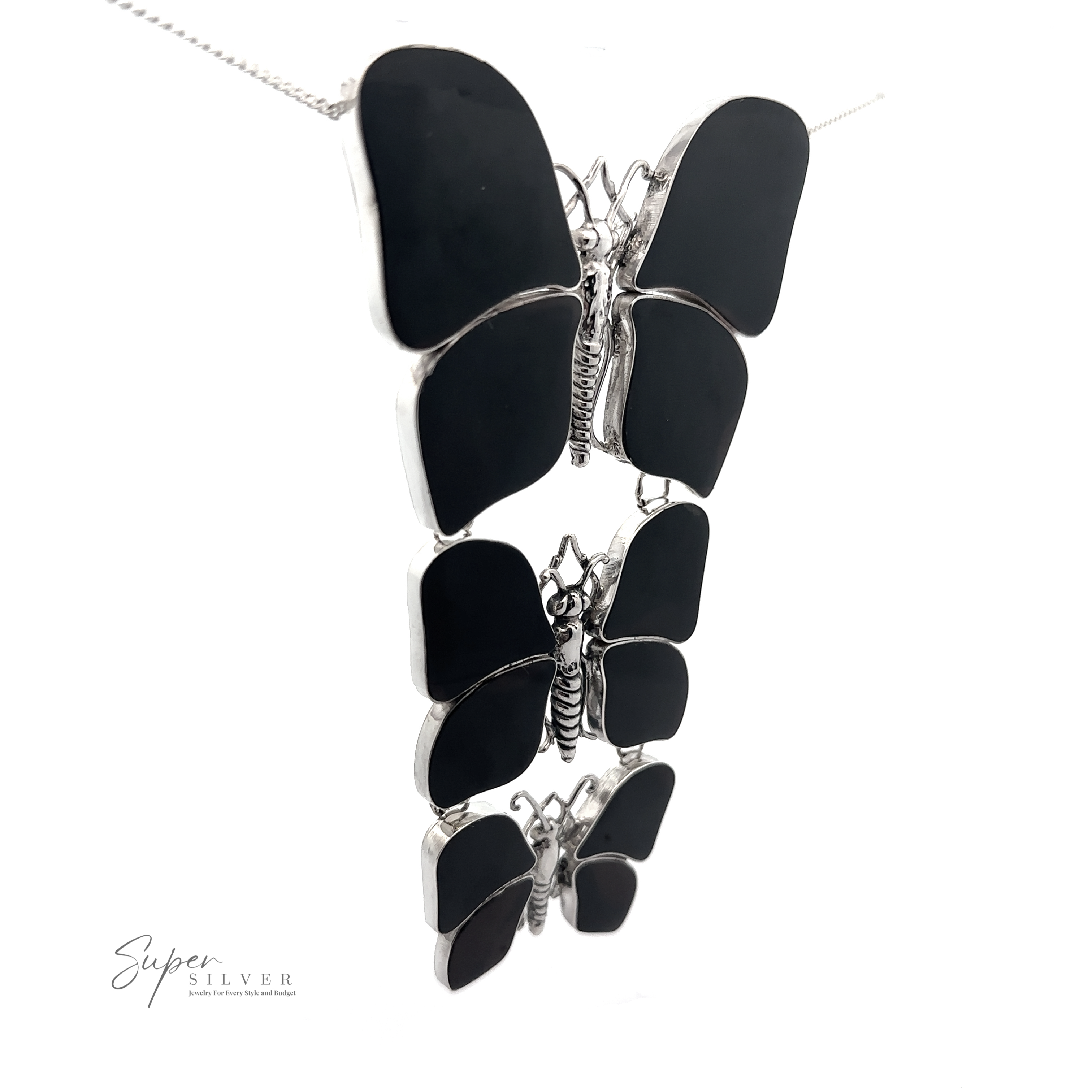 Three stacked Statement Pendant or Brooch with Three Butterflies on a sterling silver chain. "Super Silver" is written in script in the lower left corner, perfect for any nature lover.