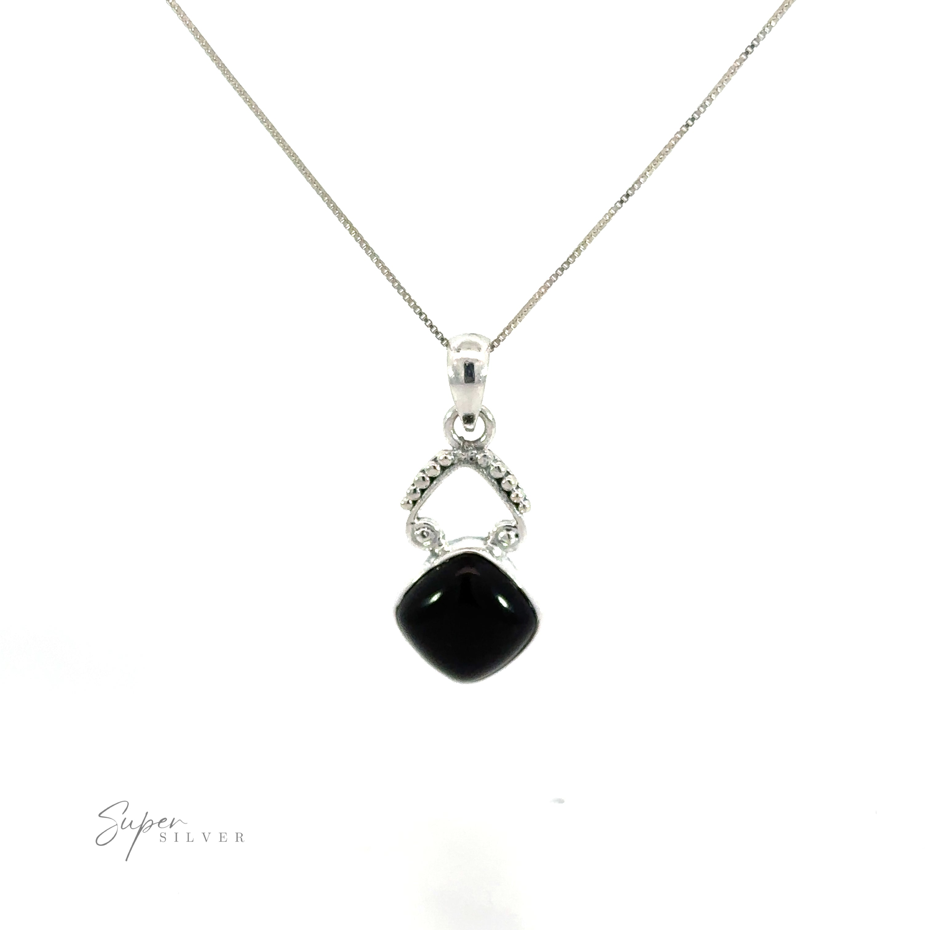 A diamond shaped gemstone pendant with a bohemian flair, featuring a black onyx and diamond design, displayed beautifully on a white background.