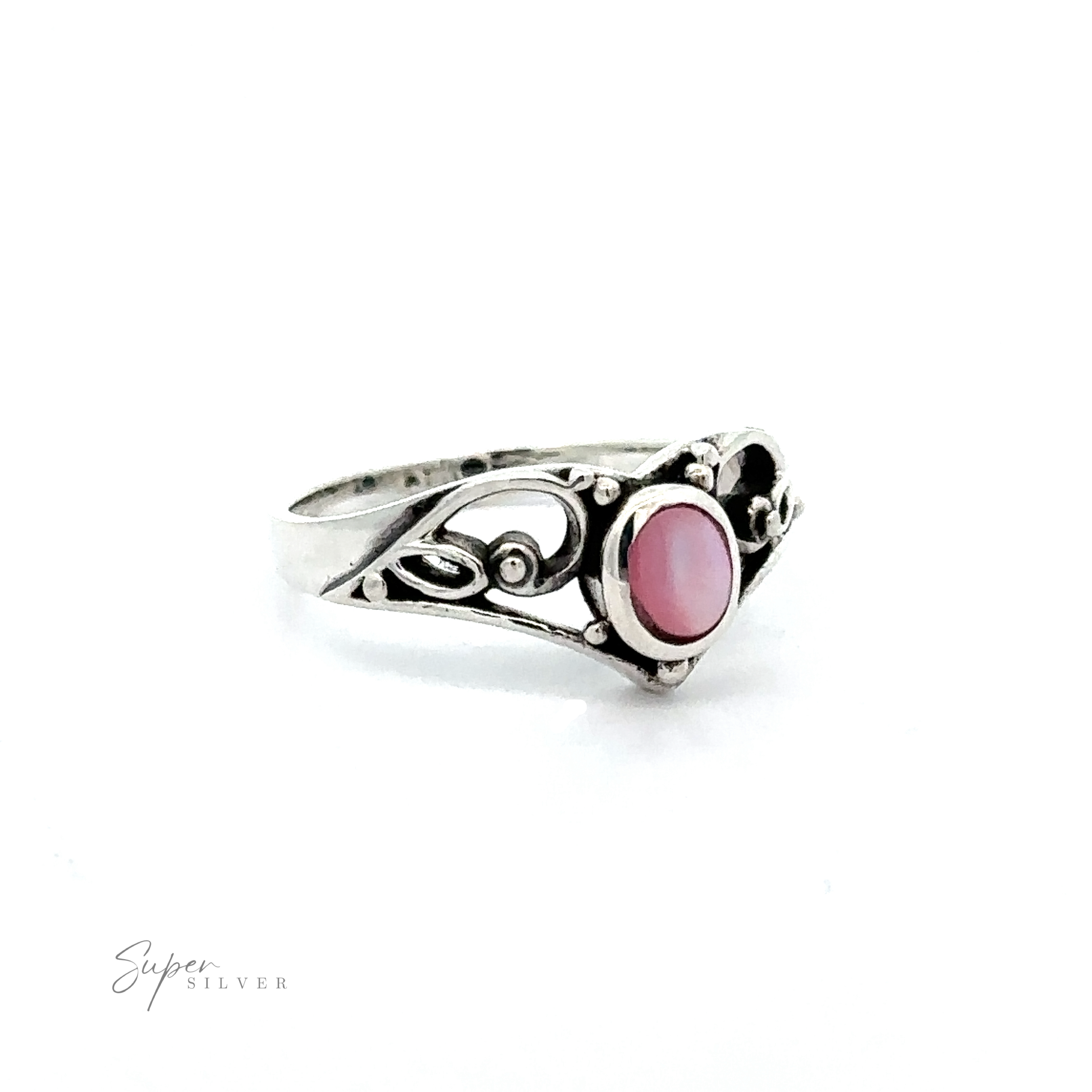 This Filigree Crown Ring with Inlaid Oval Stone has a vintage vibe, featuring a silver band adorned with intricate filigree details. Its elegant design is further enhanced by the addition of a beautiful pink.