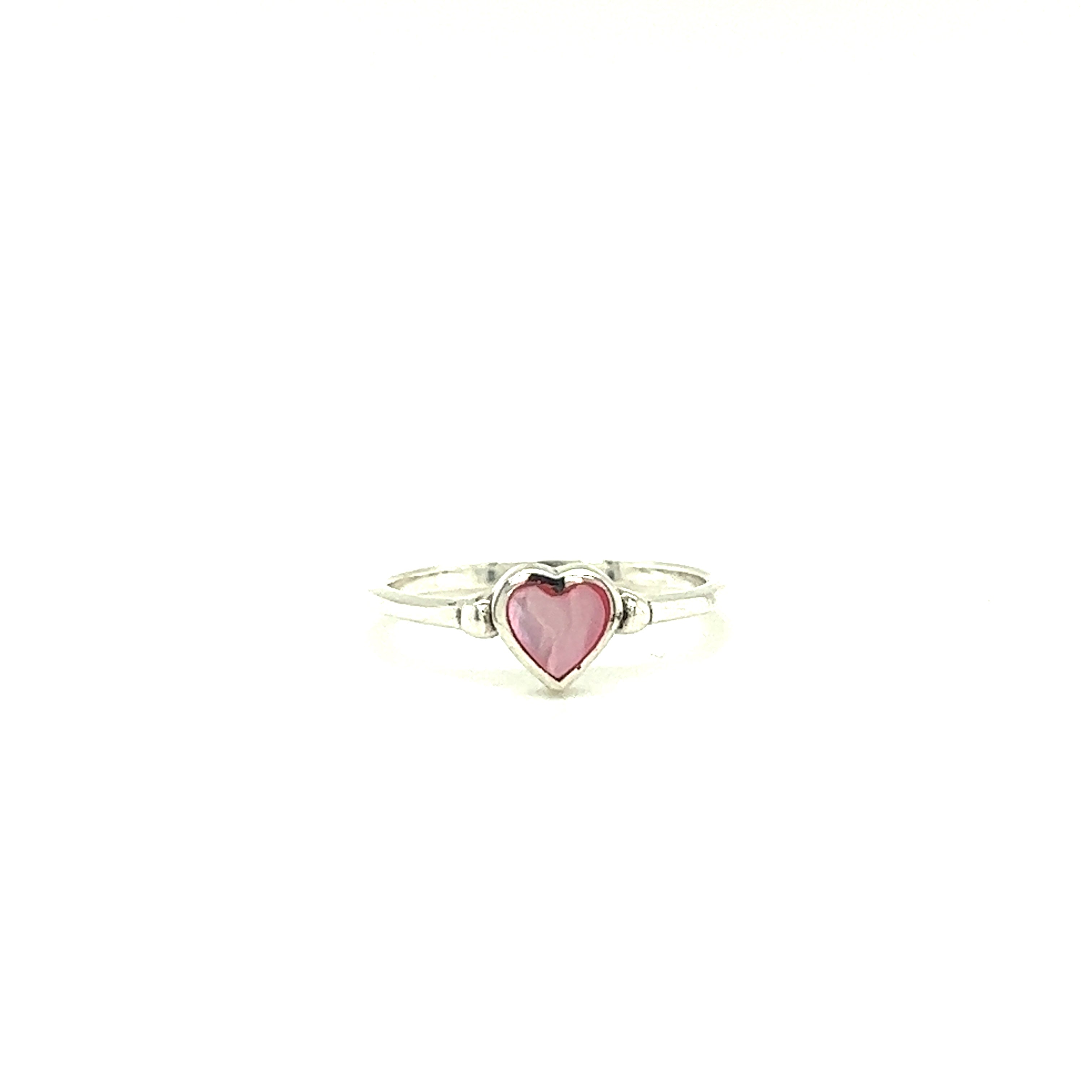 A Dainty Inlaid Heart Ring with a pink stone on a white background.