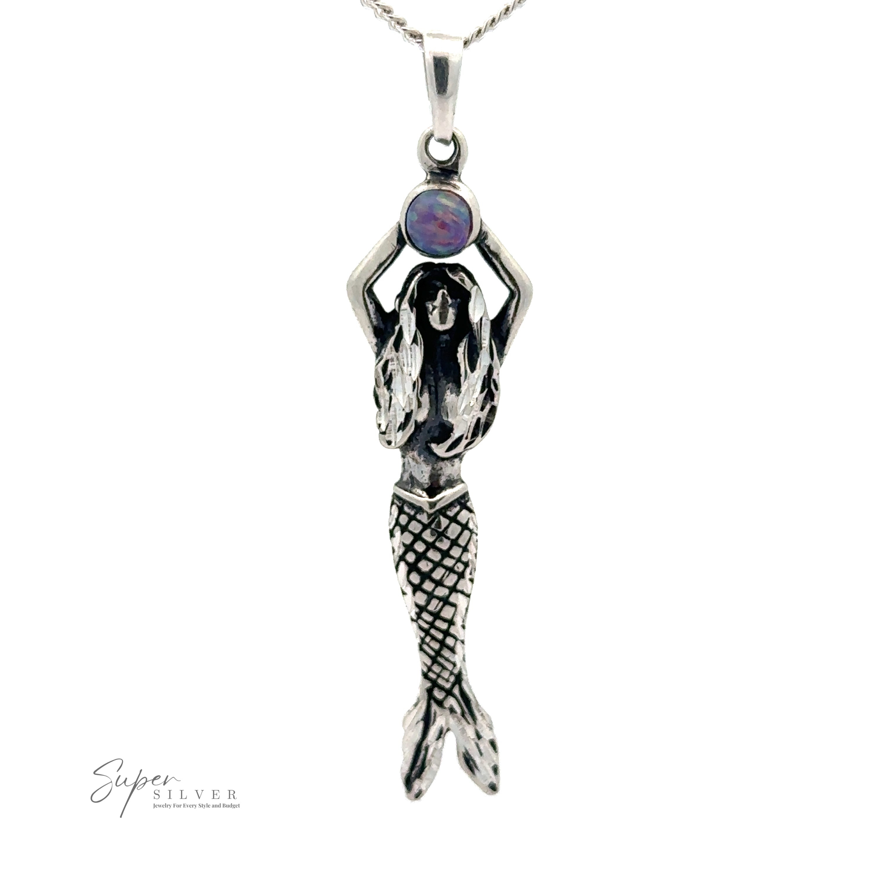 Mermaid And Opal Pendant with her hands raised, holding an opal stone. The mermaid has detailed scales on her tail and long flowing hair, crafted from oxidized silver. The logo "Super Silver" is visible at the bottom left.