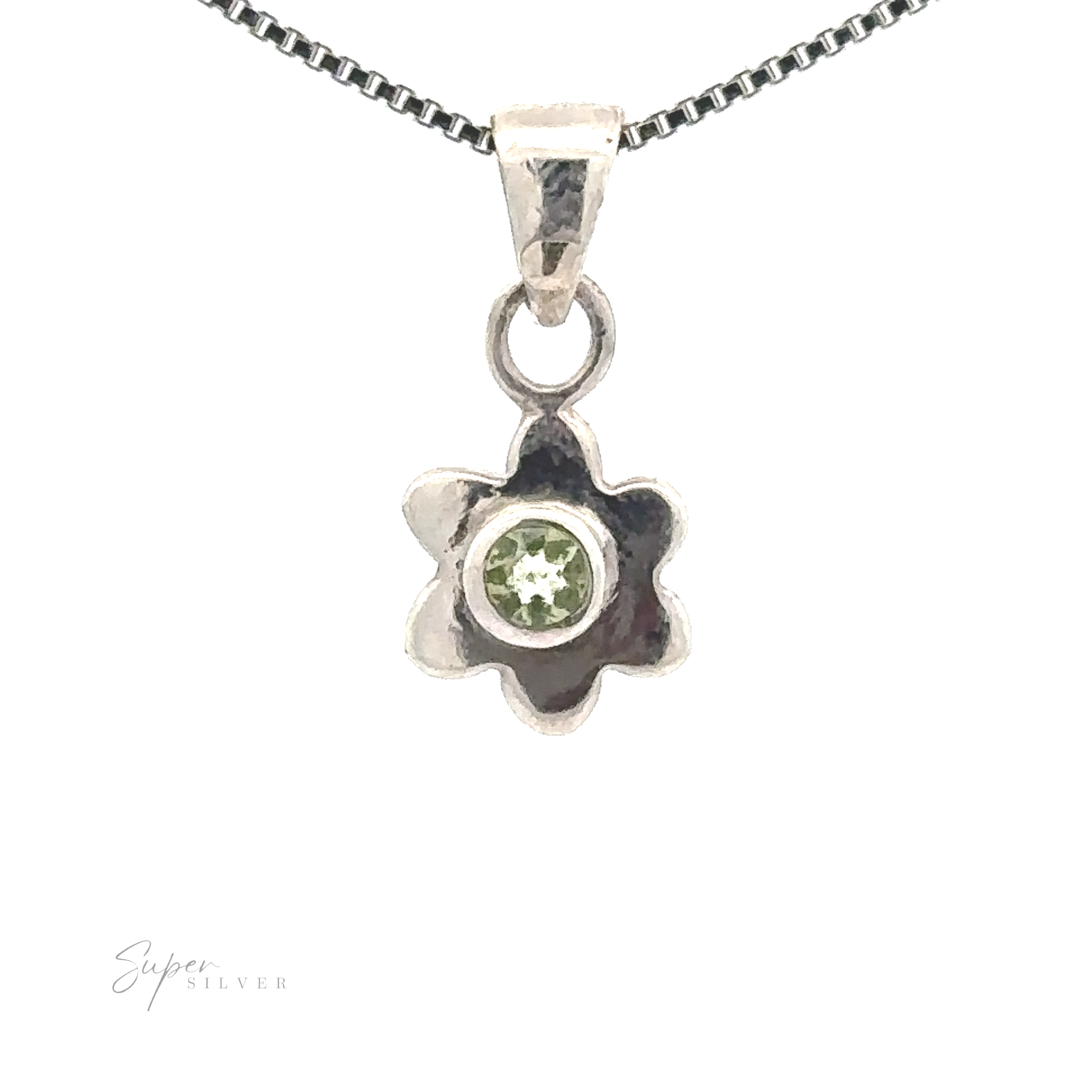A Tiny Gemstone Flower Pendant with a green gemstone at its heart, showcasing a delicate flower design, hangs elegantly from a silver chain necklace.