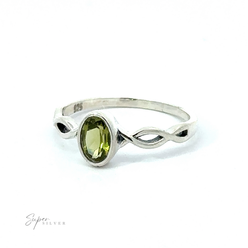 
                  
                    Dainty Oval Gemstone Ring with Twisted Band featuring a sparkling oval green gemstone set in a twisted band with an infinity symbol design, displayed against a white background.
                  
                