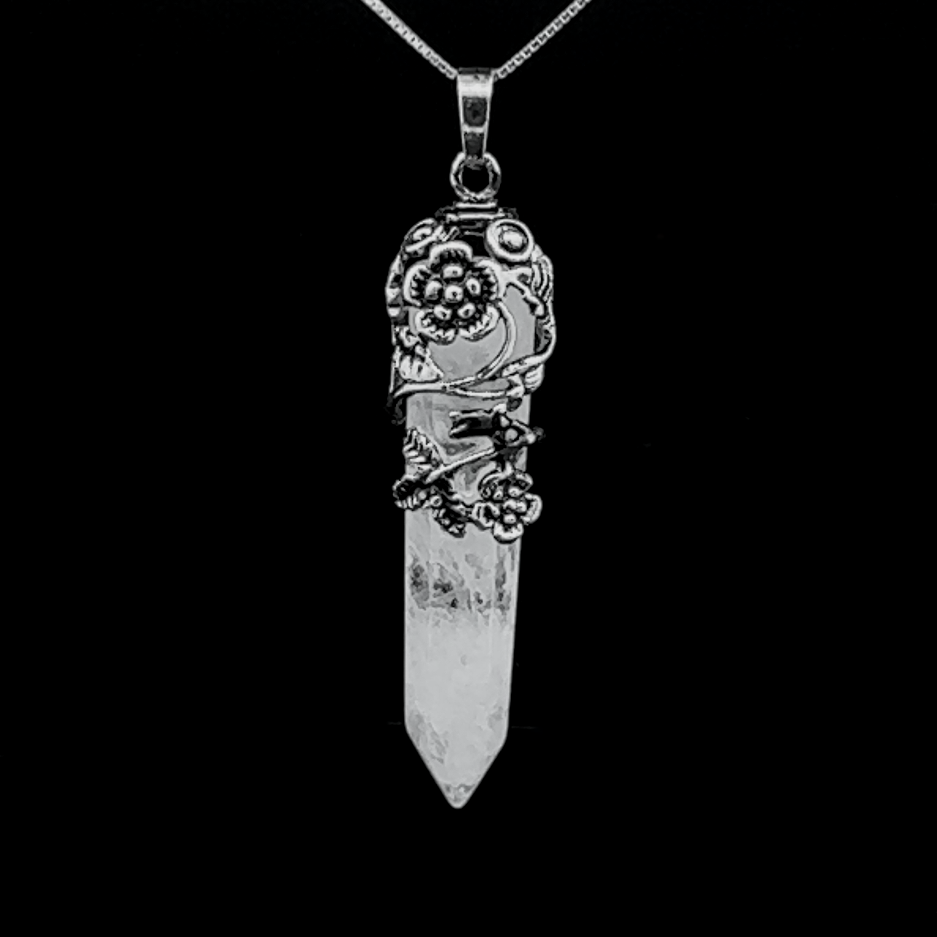 A Silver-Plated Flower Design Stone Pendant suspended from a silver-plated flower chain against a black background.